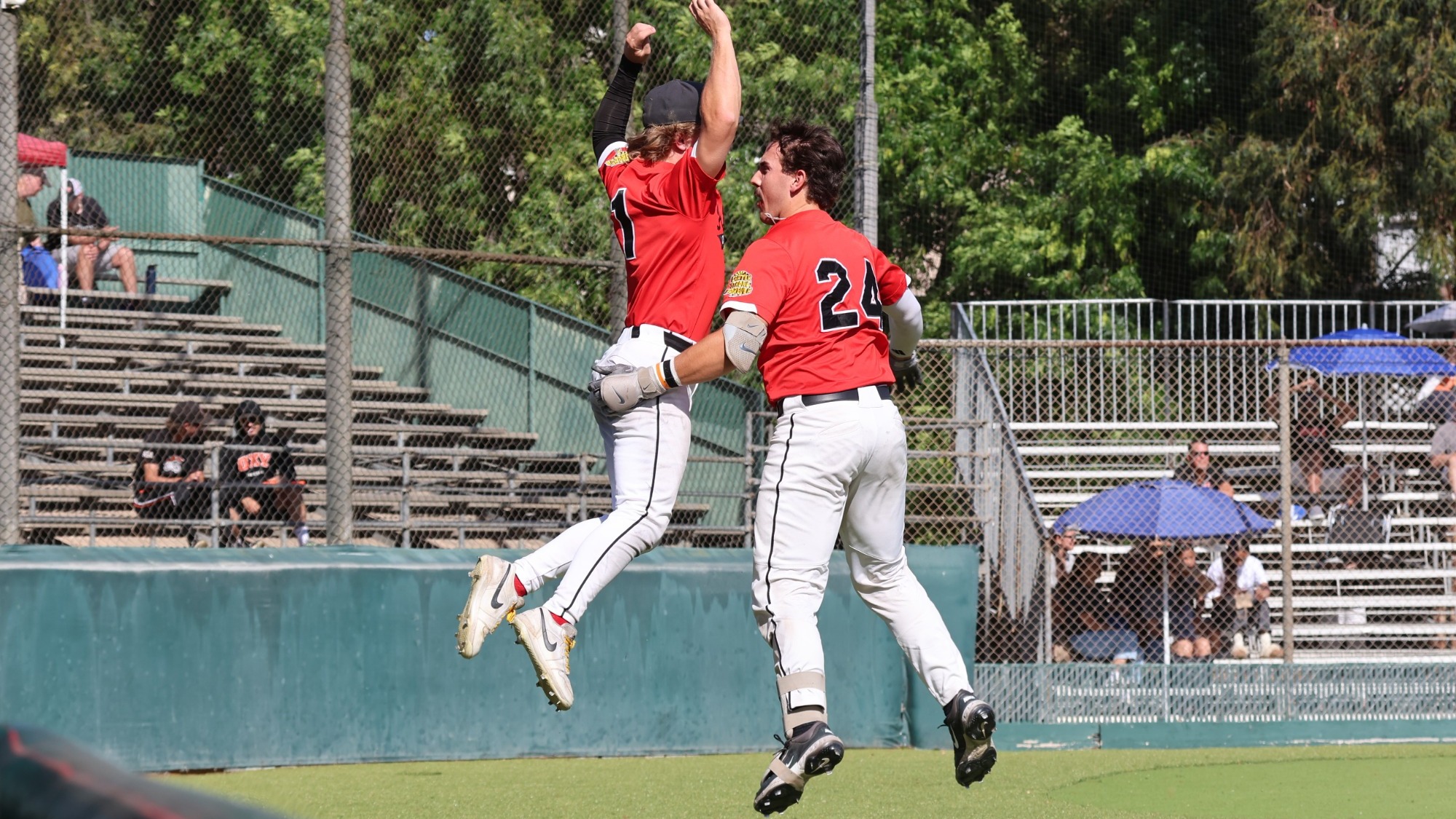 Lucas Perez and Brady Altman jump in the air to celebrate a home run.