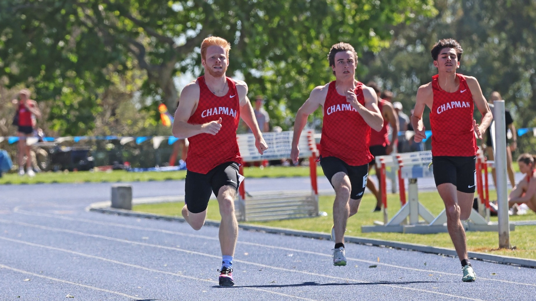 Mason Fara runs next to his teammates on the track.