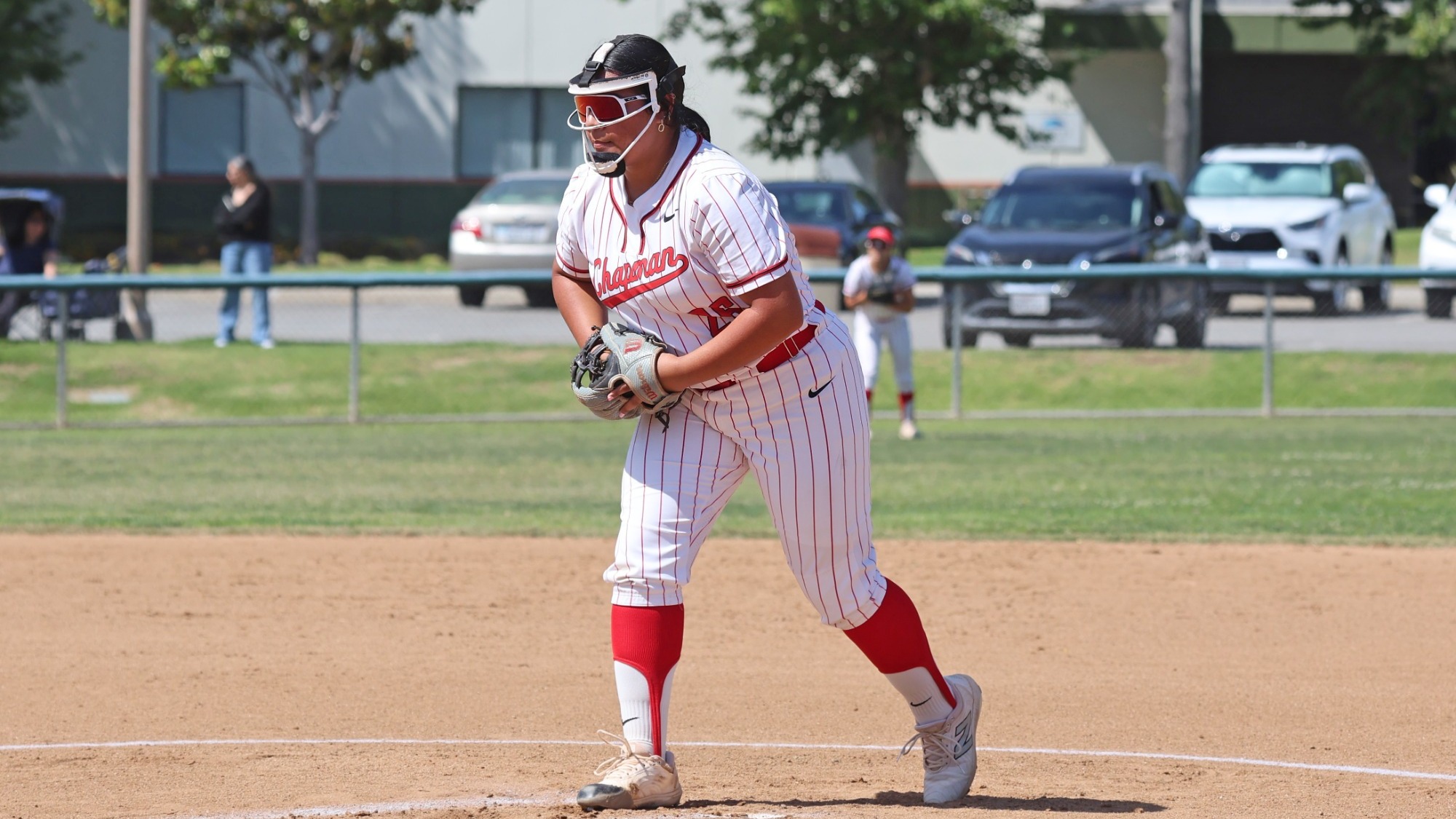 Anabell Hinojosa on the softball field preparing to throw a pitch.