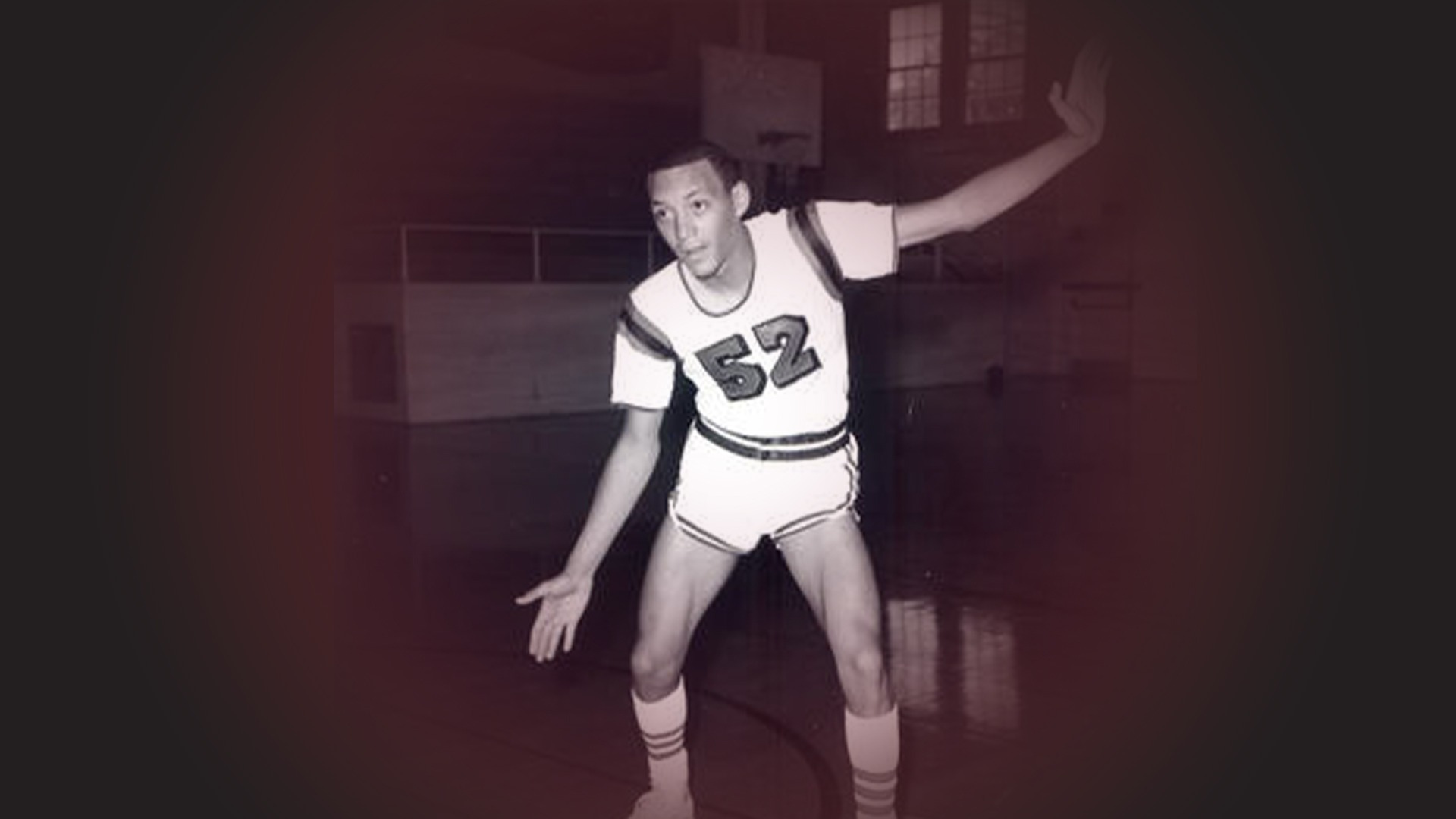 Steve Simmons in a defensive stance on the basketball court.