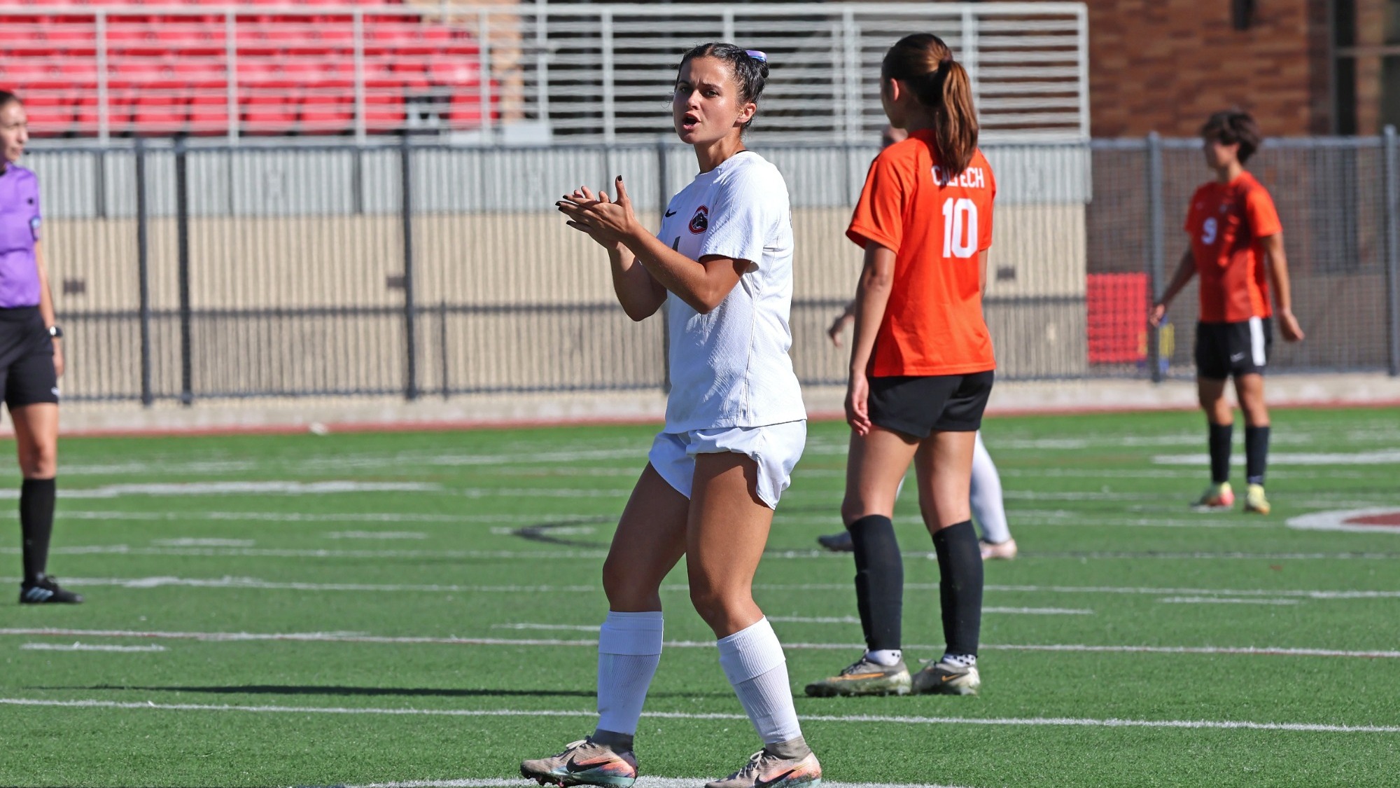 Annabelle York clapping on the soccer field.