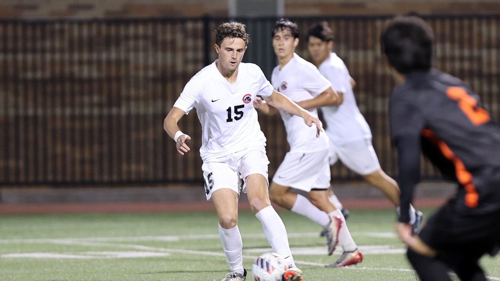 Evan White kick the soccer  ball.