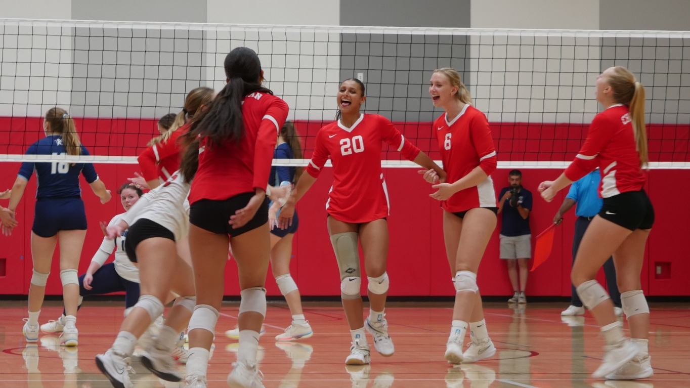 Sasha Pugh celebrates with her teammates after scoring a point.