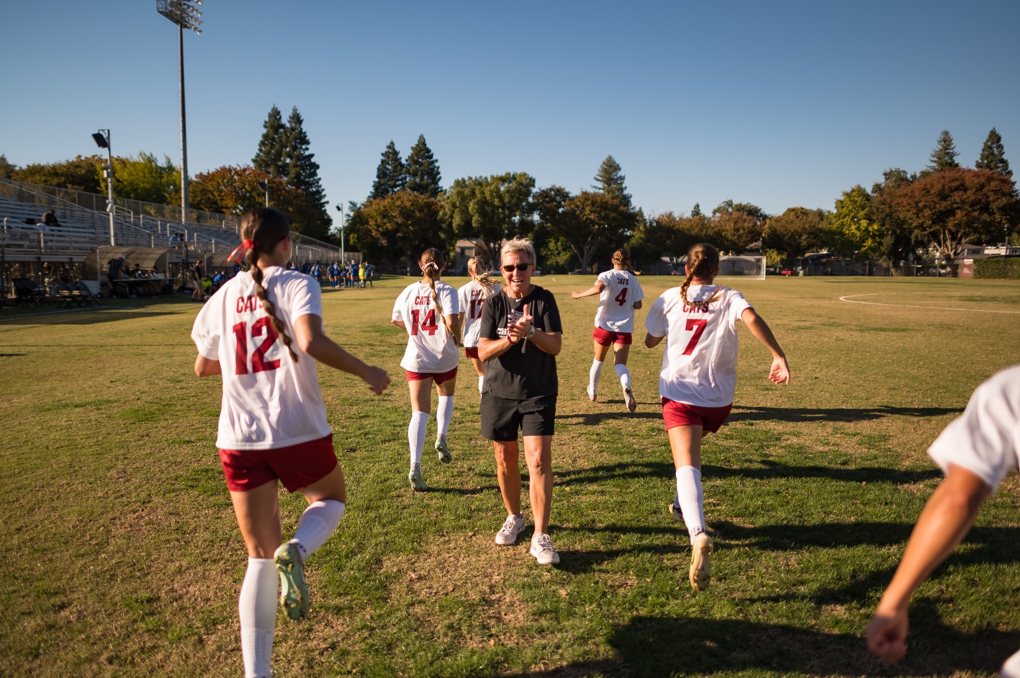 Chico State Wildcats’ Head Women's Soccer Coach Kim Sutton (center) warms up against Cal State San Bernardino Coyotes before the first half of their Women's Soccer (WSOC) game on Friday, October 17, 2025 in Chico, Calif.(Jason Halley/University Photographer/Chico State)
