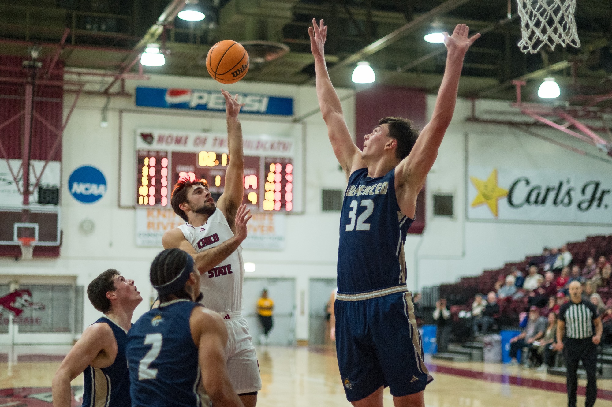 Ned Joyce shooting a floater over a tall UC Merced defender in win over the Bobcats