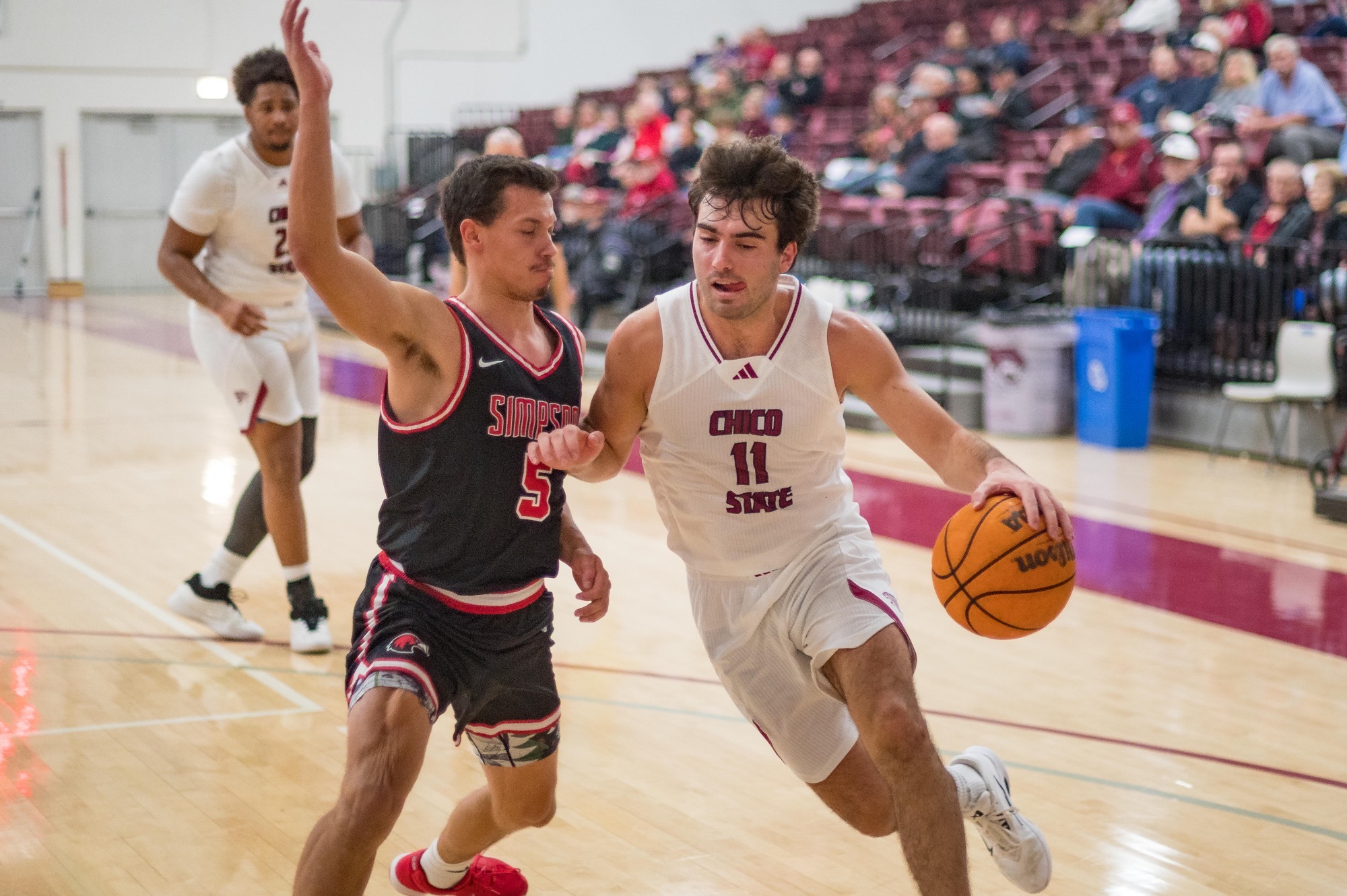Max Walters dribbling at a Simpson's player at home with tongue out