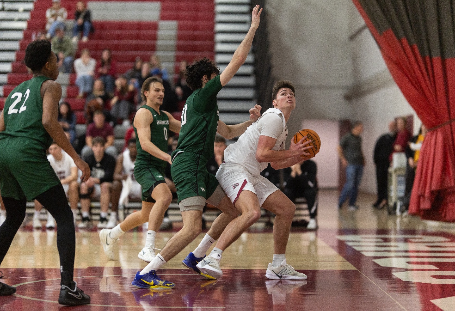 Braddock K. holds onto the ball looking for a chance to go up for a layup below a CPP player