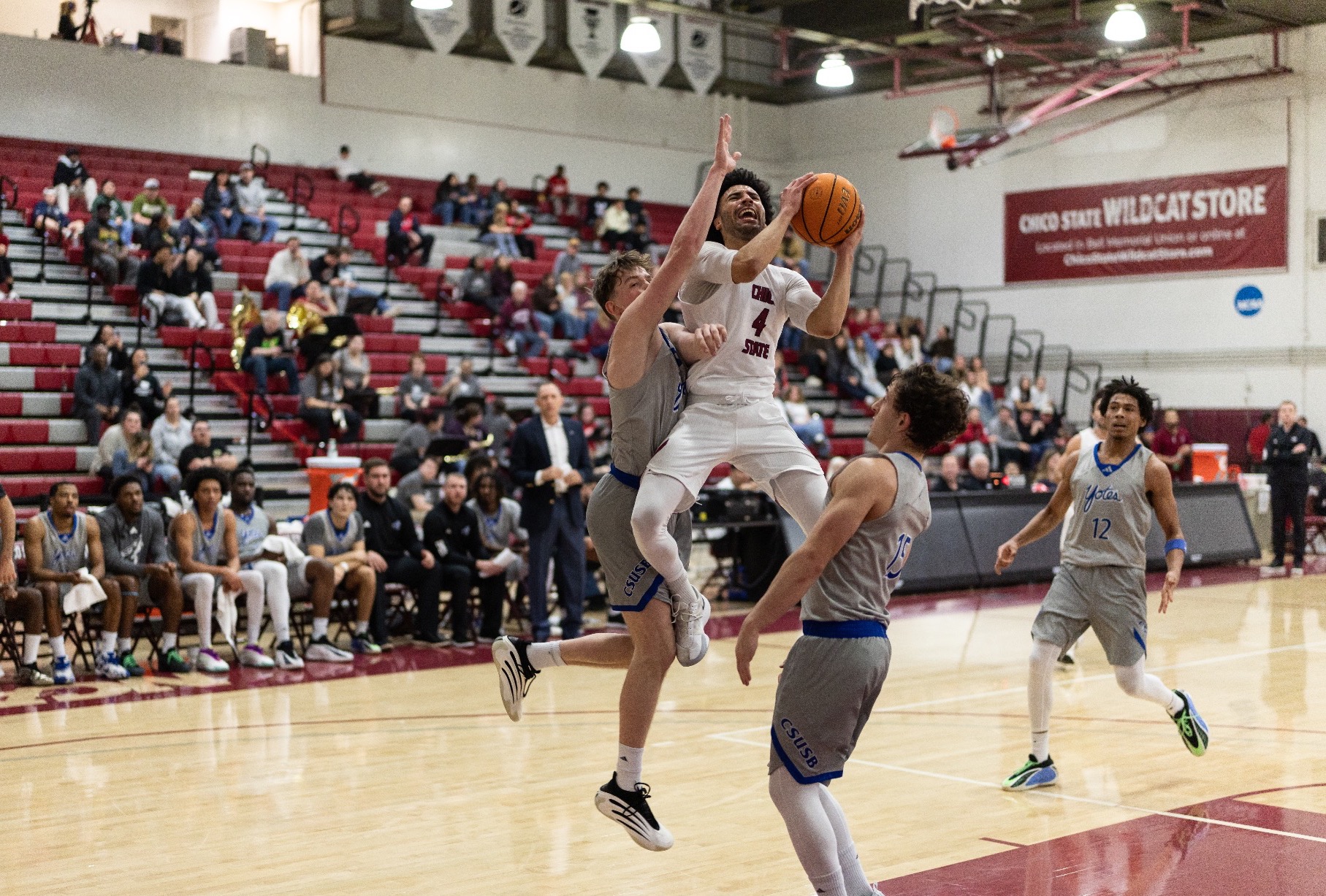 Chris Holley drawing a foul against two Coyotes players