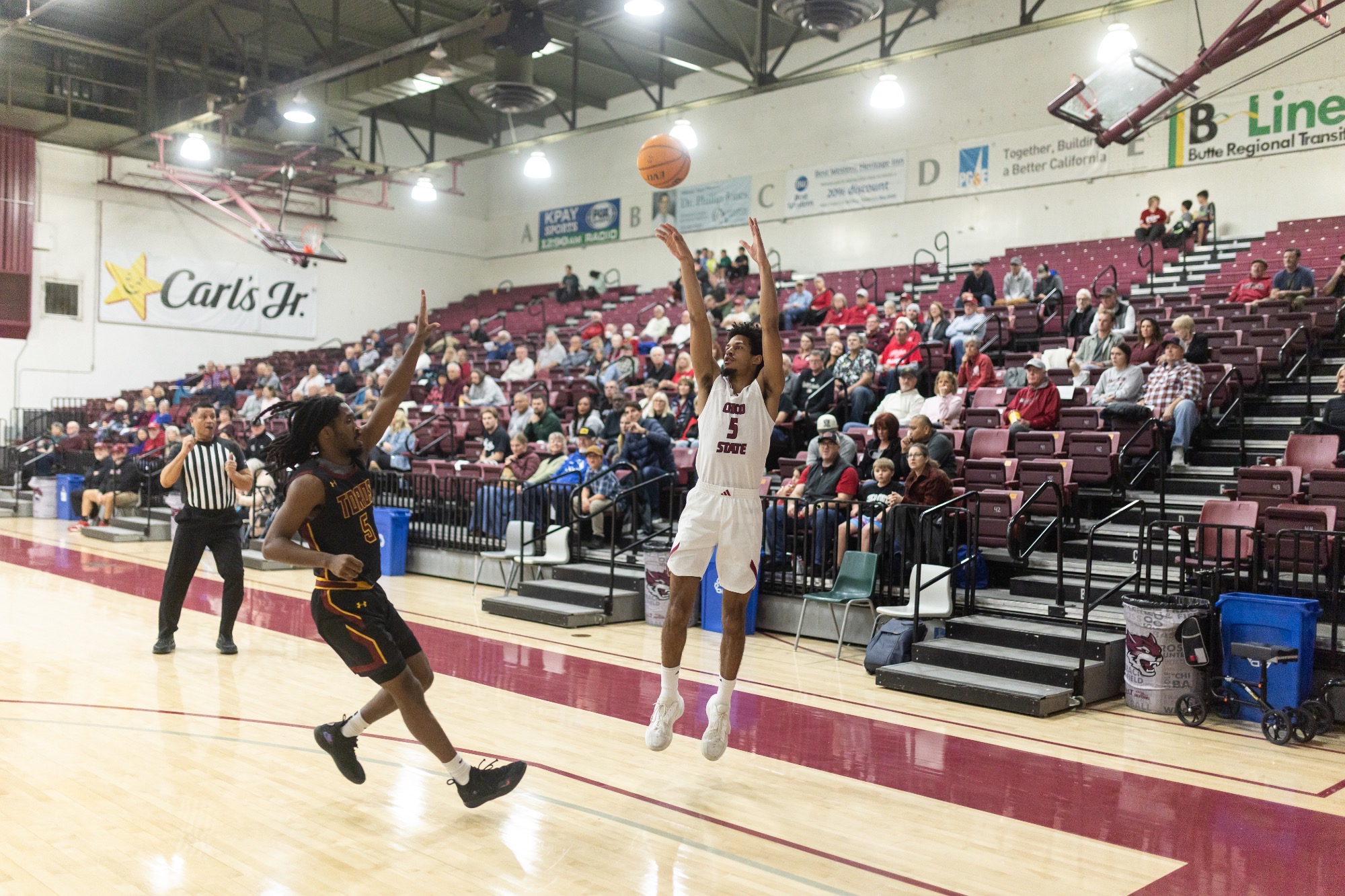 Dargan shooting a jump shot as a CSUDH player closes out