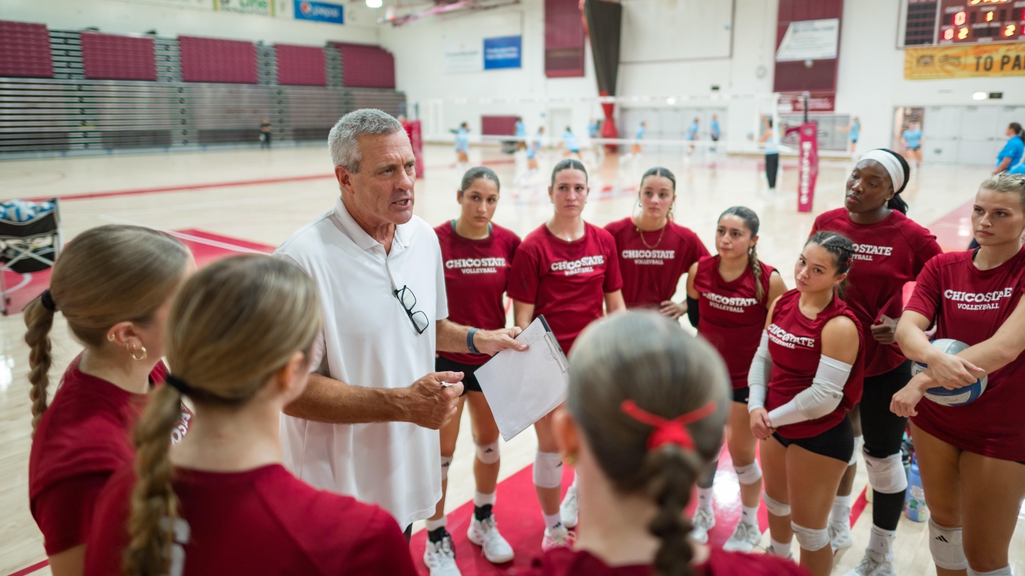 Chico State Wildcats’ Interim Head Volleyball Coach Ricci Luyties (center) talks to the team warms up against Cal State Monterey Bay Otters before the first game of their Volleyball (WVB) match on Thursday, September 24, 2026 in Chico, Calif.(Jason Halley/University Photographer/Chico State)