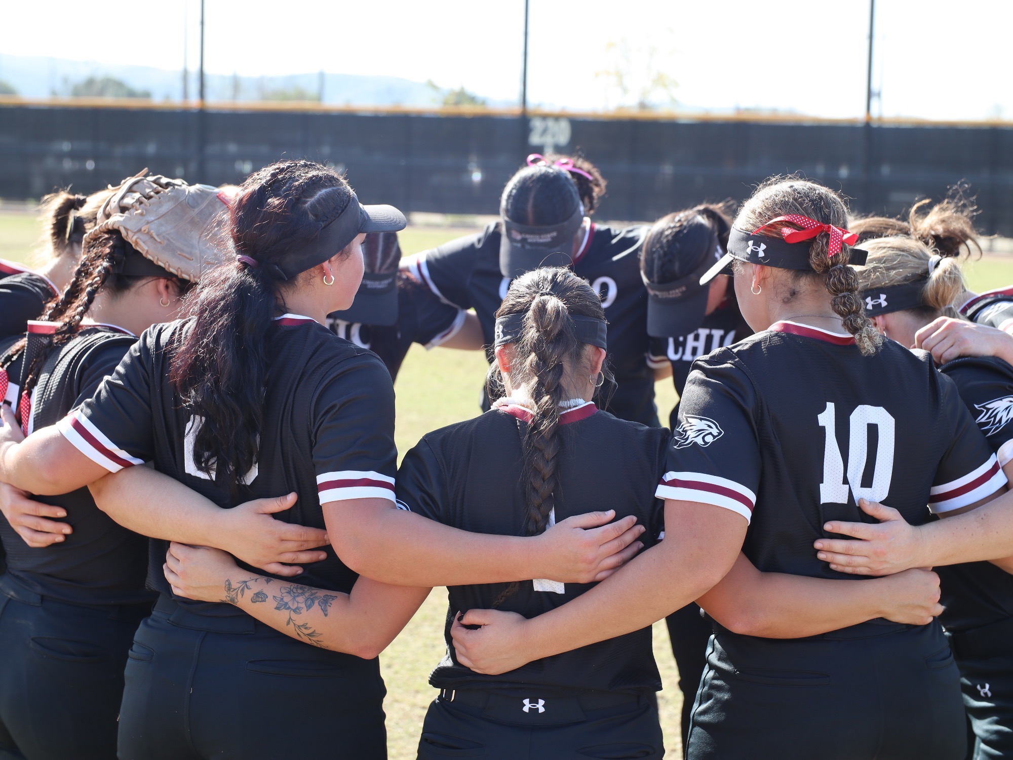 Chico State Softball huddled up before game 4 of the CUI Kickoff Classic