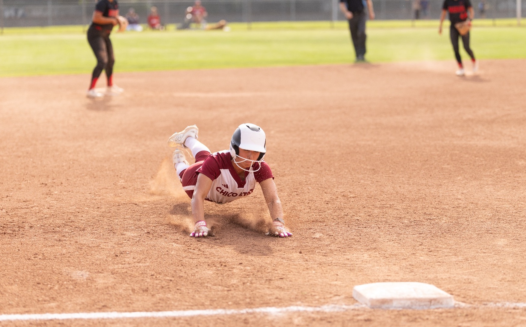 Wildcat Softball player diving to third base against Stan State