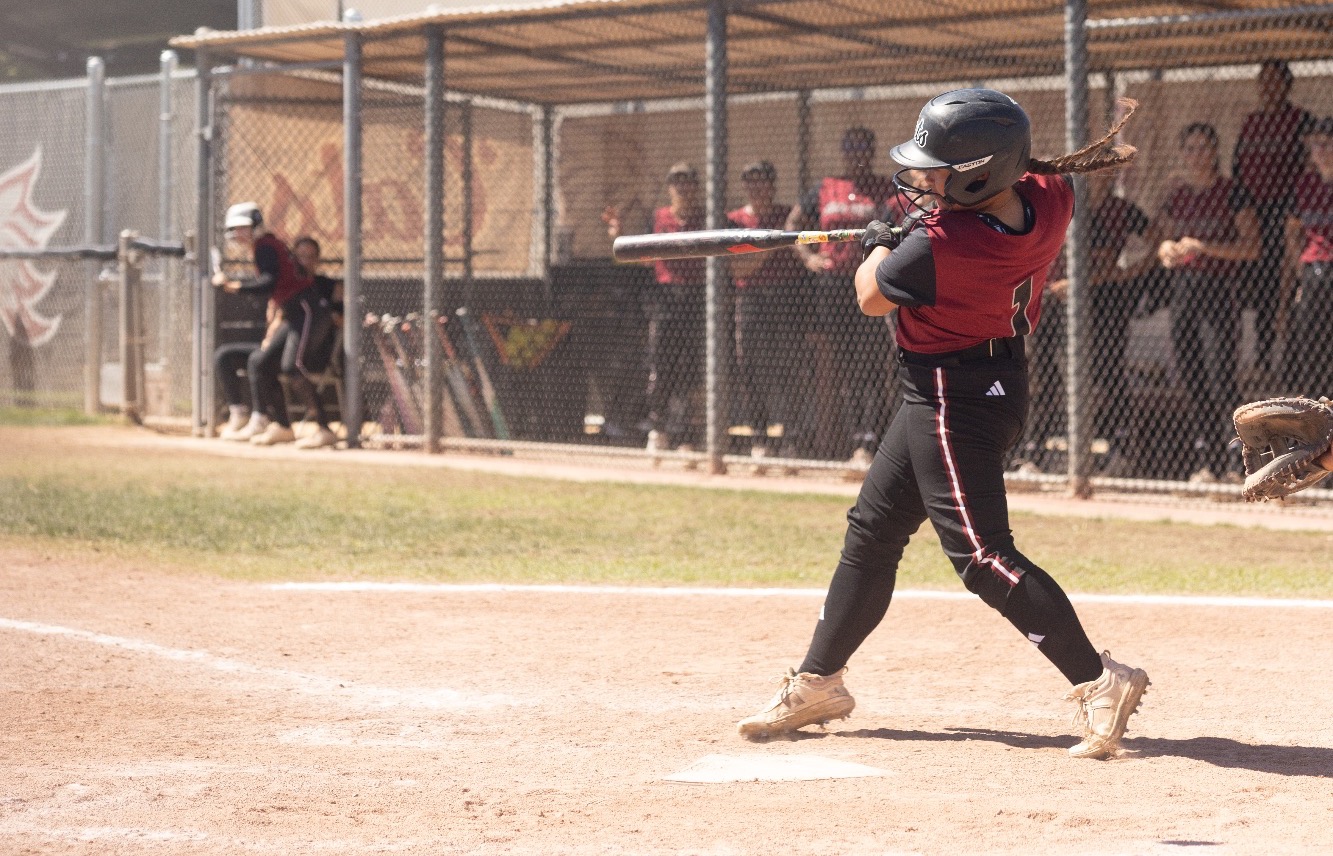 Mia Santos swinging at home plate against SF State