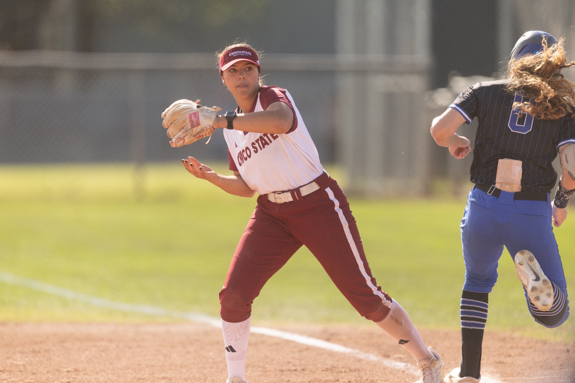 Aiyana Curry catching the ball at first base against the Cougars
