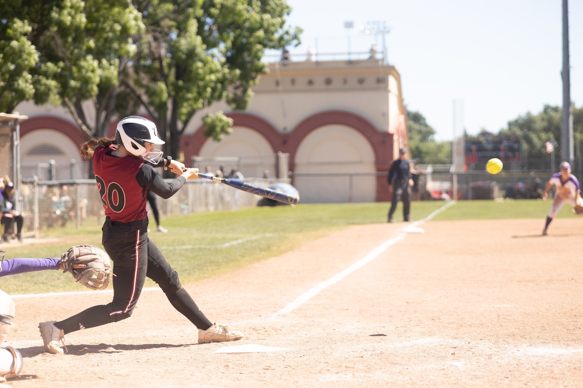 Ali Lewis at the plate and connecting with a pitch against the Gators