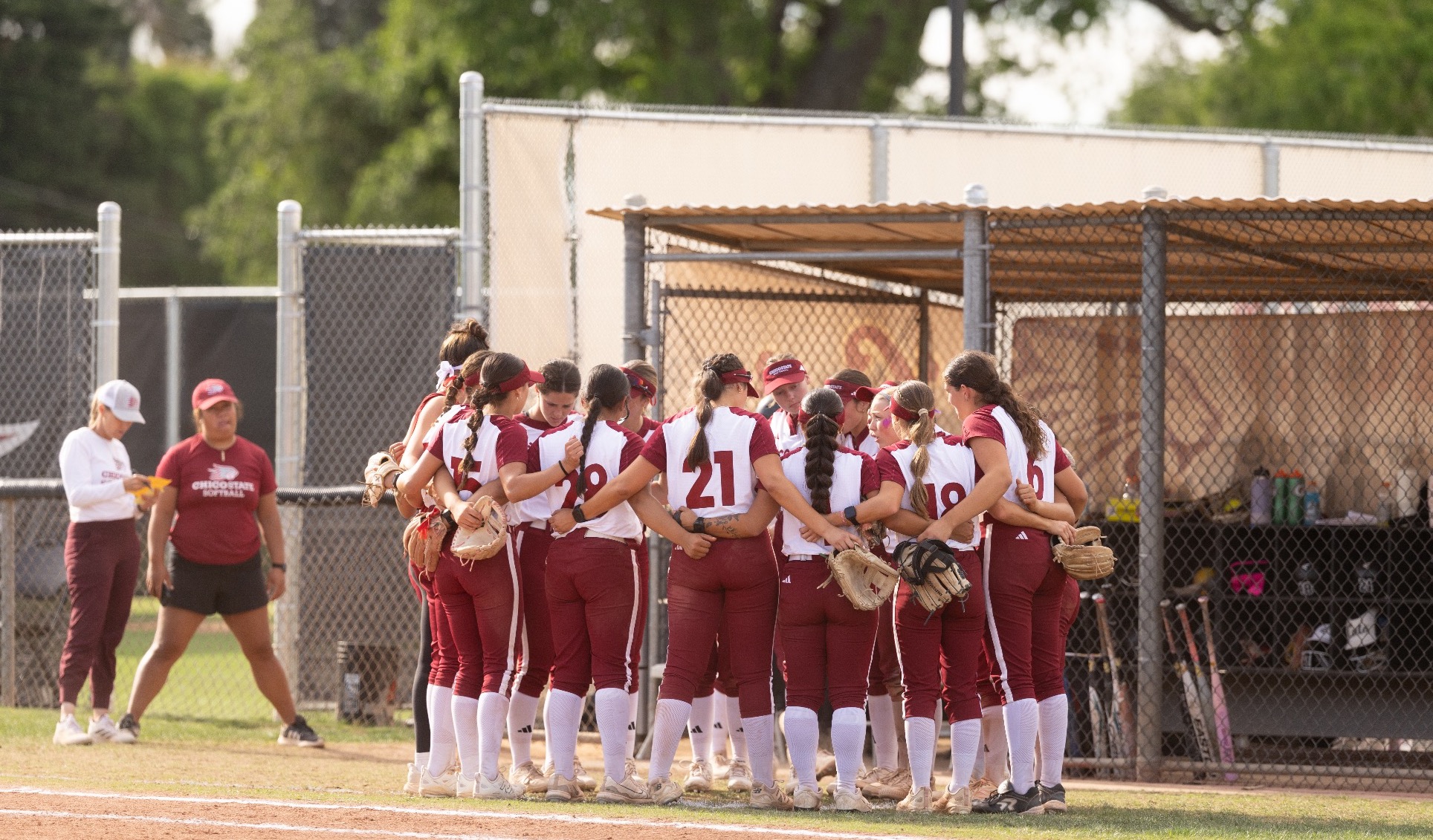 Softball huddle image vs Stanislaus State