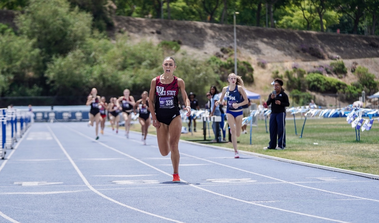 Paulina Martins cheering as she crosses the line at 2026 CCAA Championships
