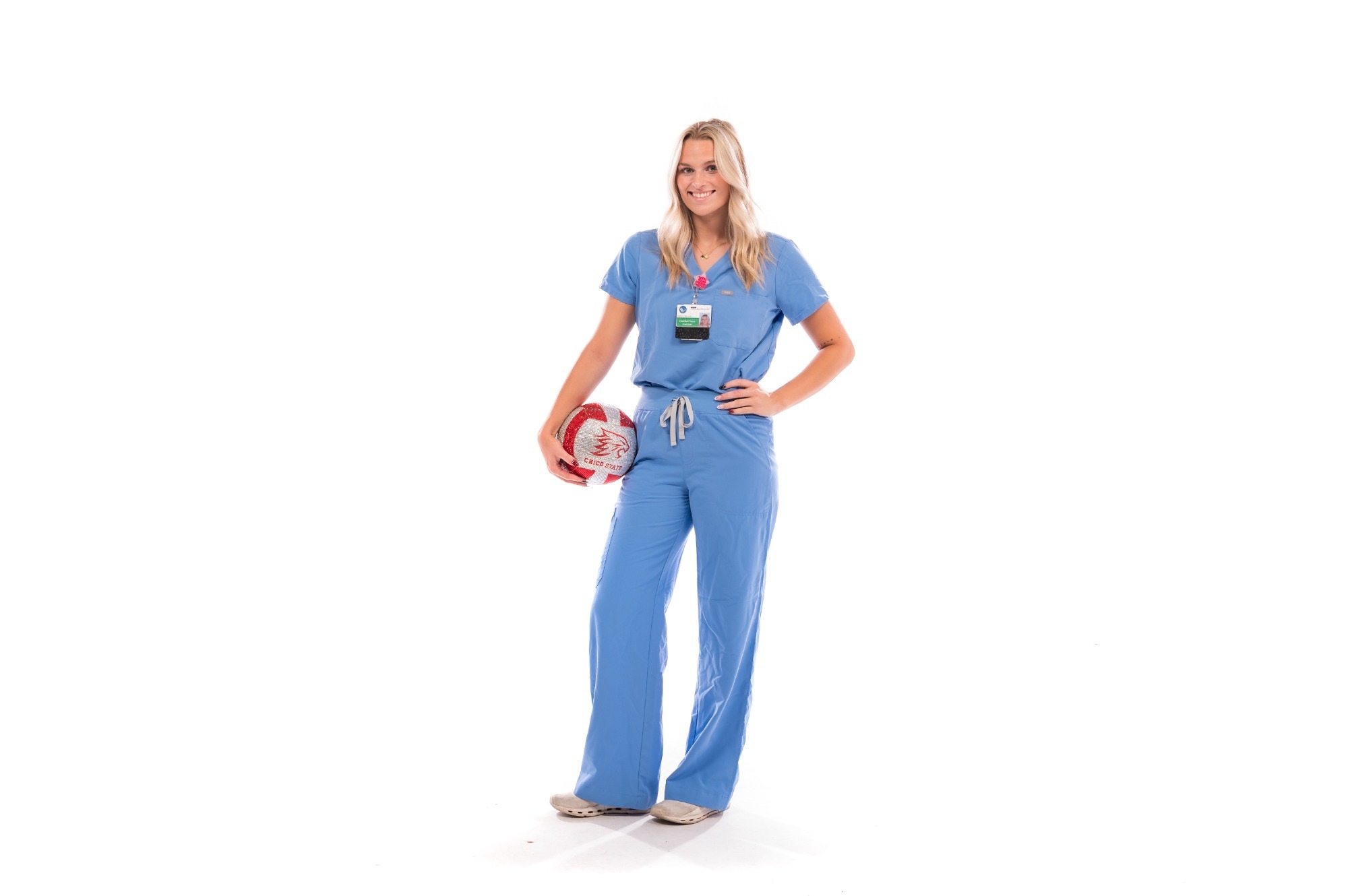 Chico Wildcats Women’s Volleyball (WVB) outside hitter Marley Harrison, who is majoring in Public Health and Health Services Administration with aspirations to go into medical school and pursue anesthesiology, is photographed in the studio wearing scrubs and holding a volleyball on Thursday, August 13, 2026 in Chico, Calif.(Jason Halley/University Photographer/Chico State)