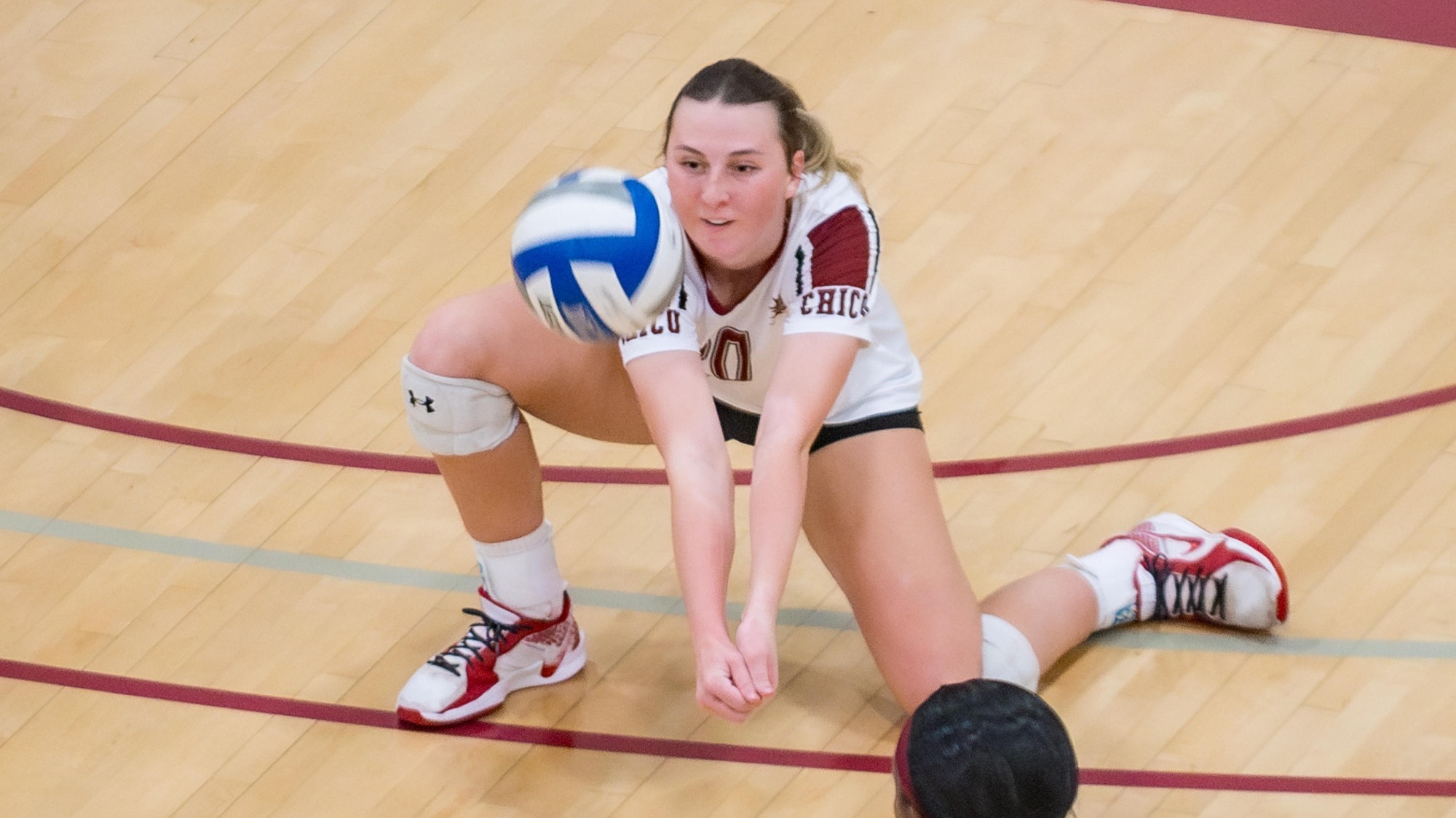 Chico State Wildcats' #20 Sophia Heller (center) digs against Cal State East Bay before the second set of their Women's Volleyball (WVB) match on Thursday, November 13, 2025 in Chico, Calif.(Jason Halley/University Photographer/Chico State)
