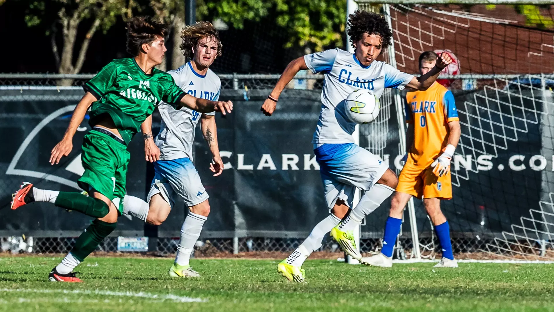 Aslan Gikaru controlling the ball against a highline defender