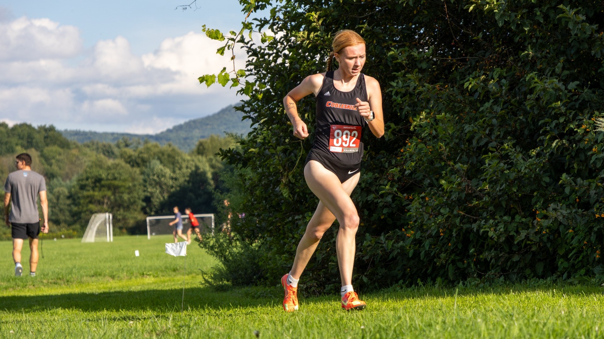 Cobleskill women's cross country Gabrielle Waite running up hill at Oneonta