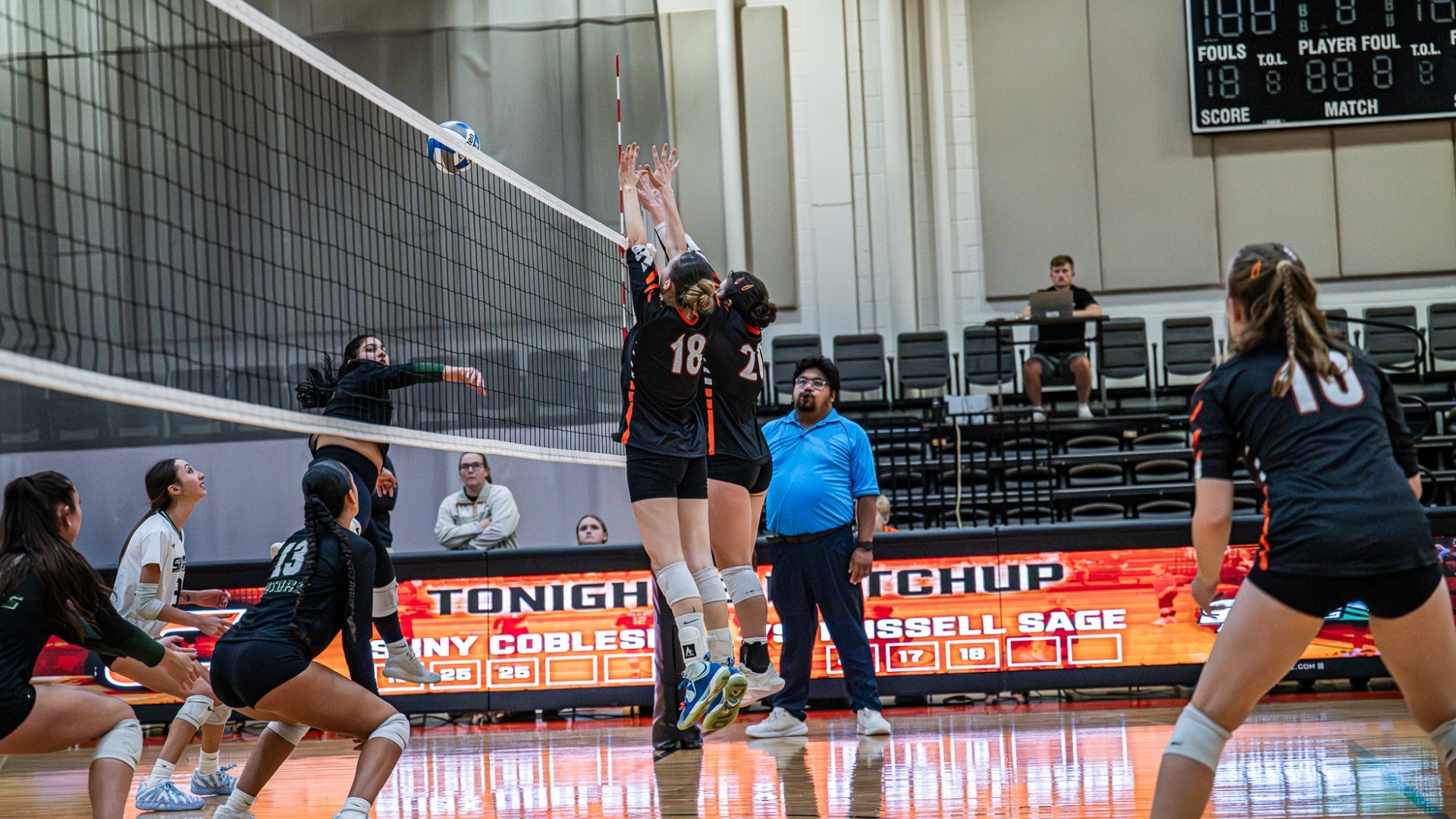 Cobleskill women's volleyball attempting to block the ball at the net