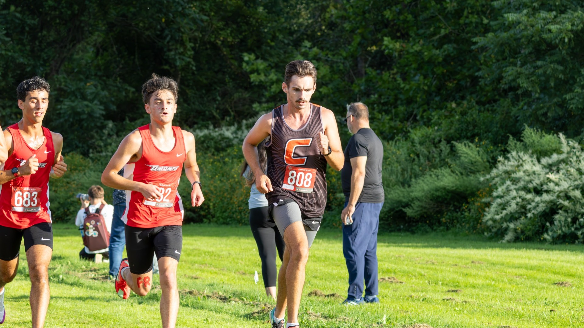 Photo Shows Aiden Pettit of Men's Cross Country Running at the Oneonta Airfield Invitational