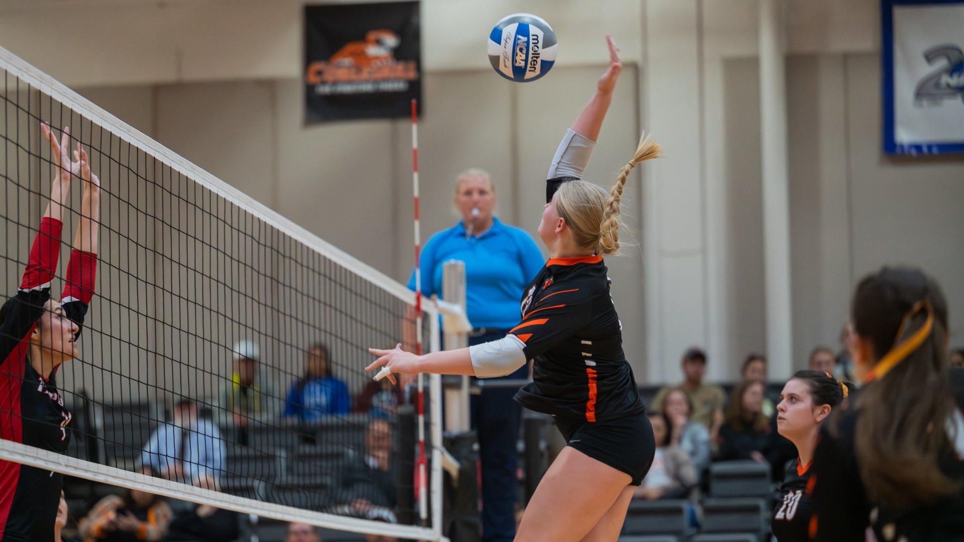 Emma Hinze going for a kill at the net against Thomas College