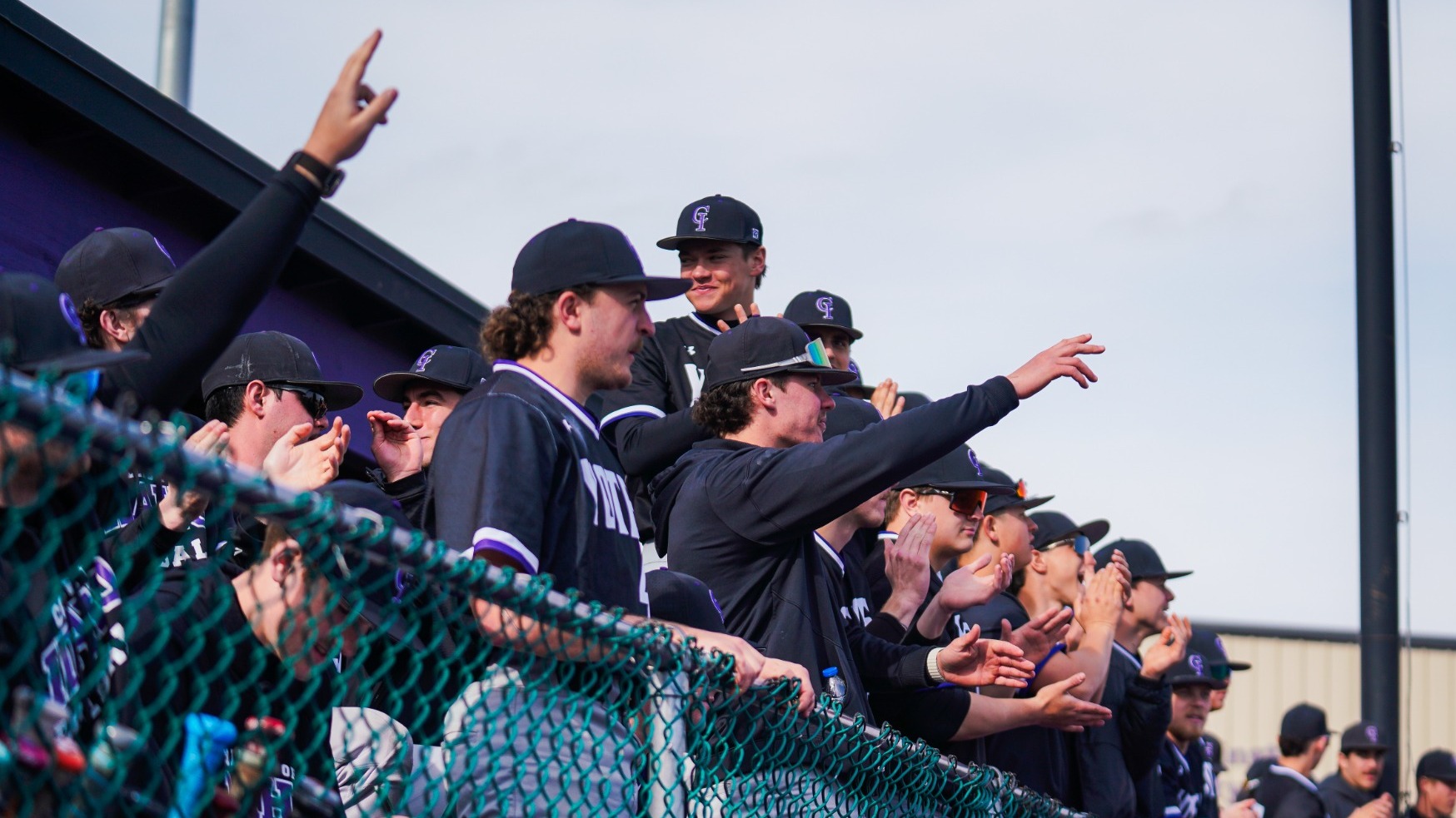 Yotes baseball dugout cheering on their team