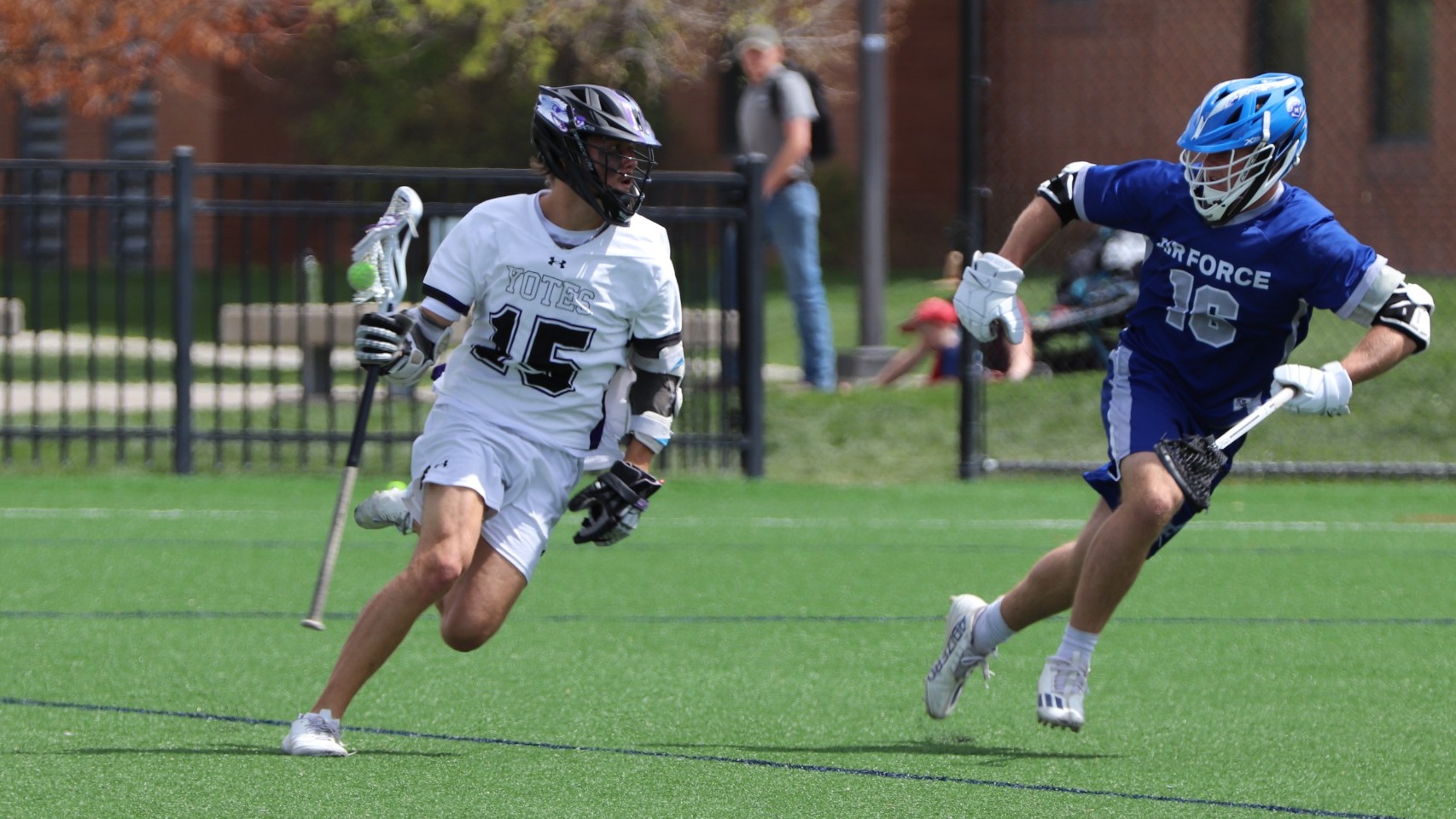 Yote running around with a stick that has a ball in it