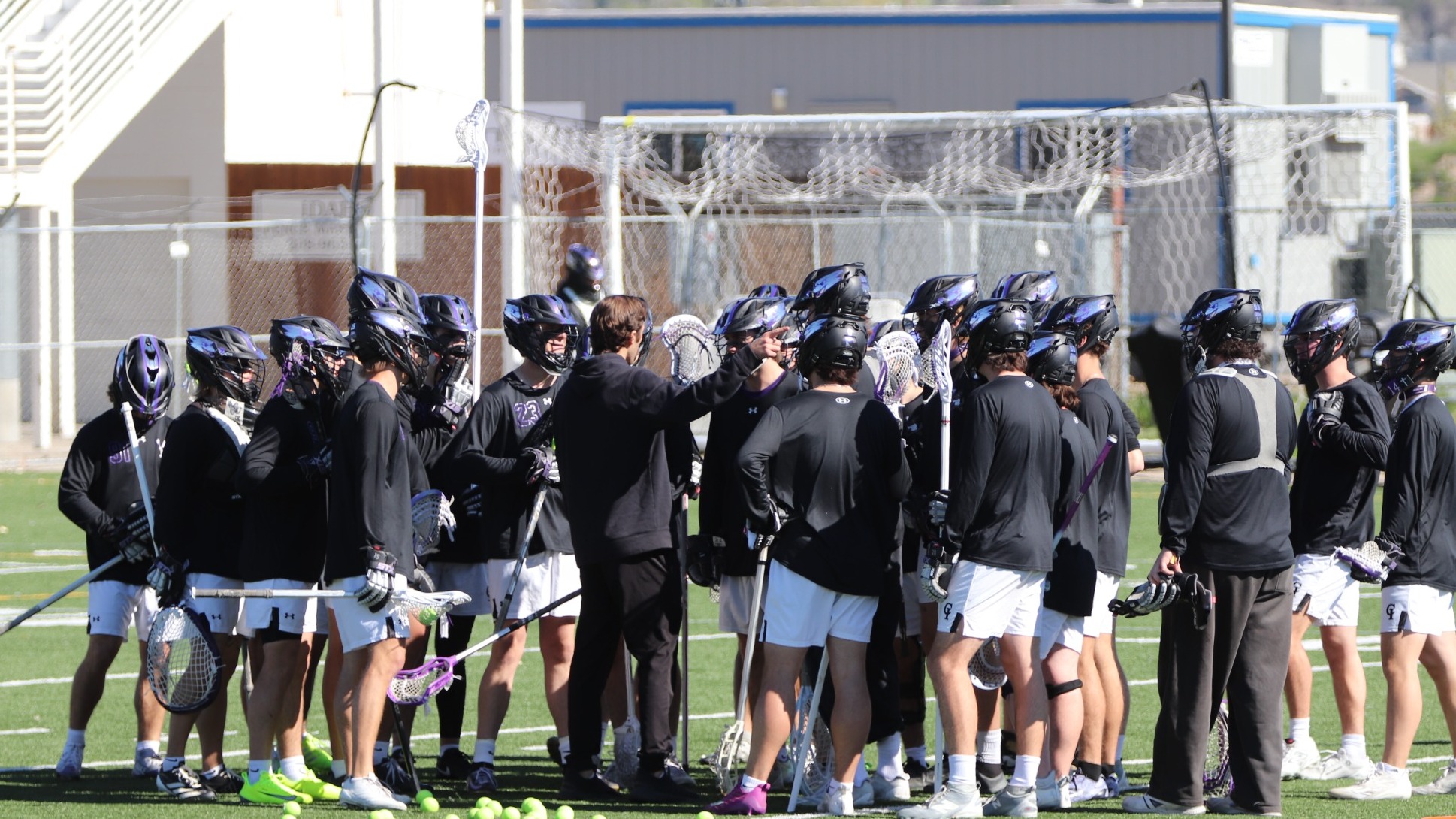 Yotes Lacrosse in a huddle