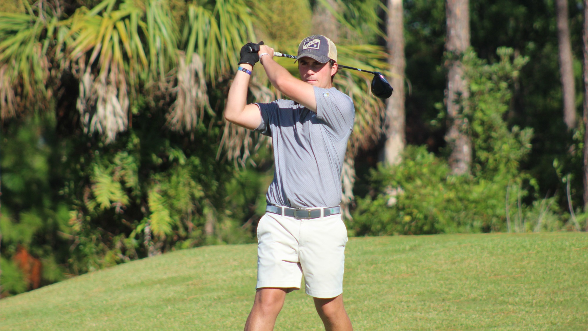 Nate Caughman swings a golf club