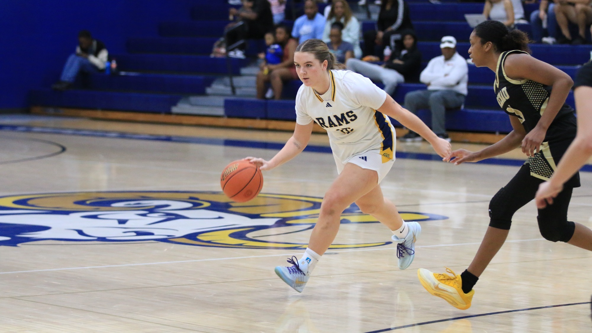 Sadie Burnette dribbles past a defender 