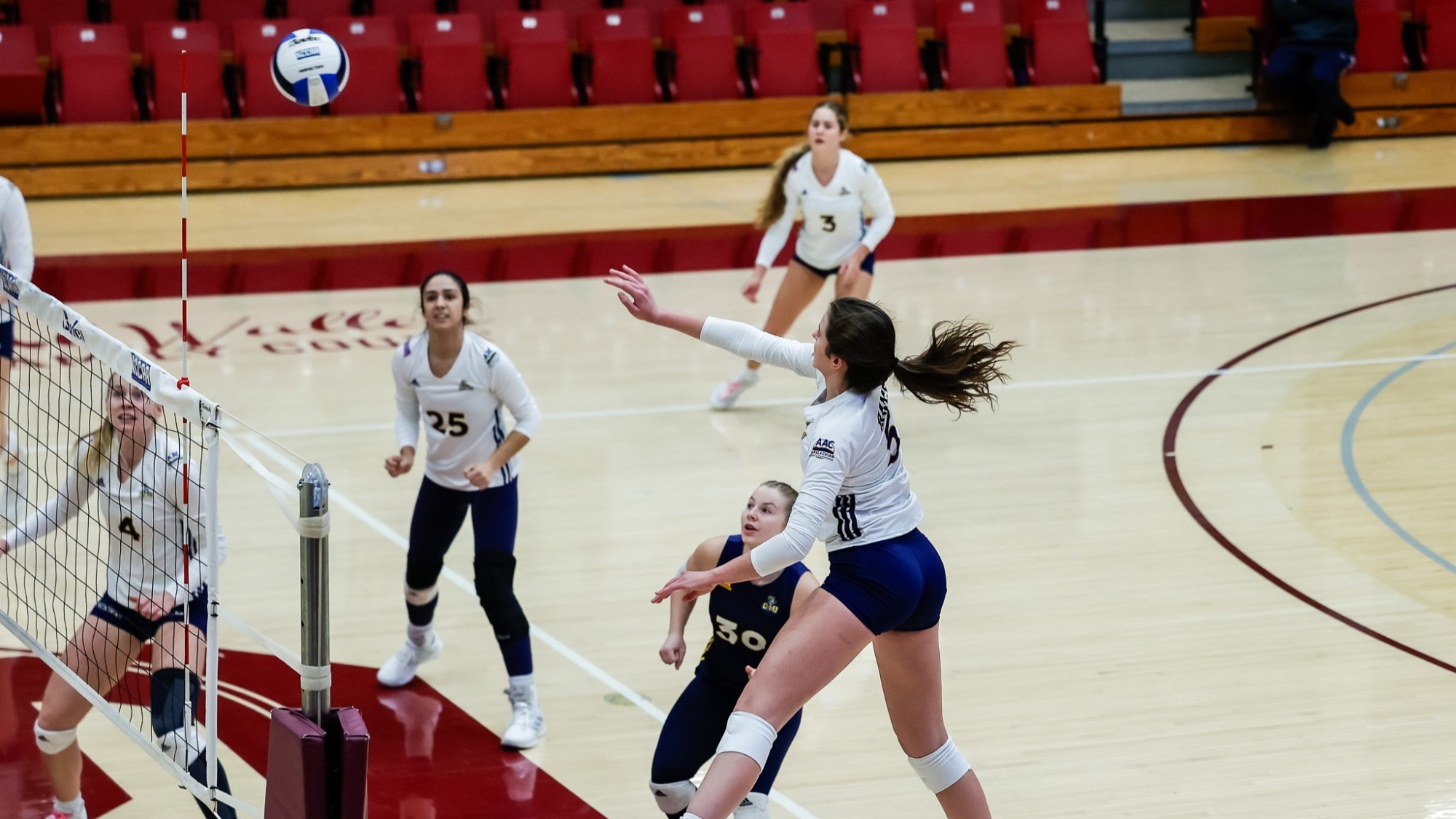 Mary Norwood attacks the volleyball for CIU