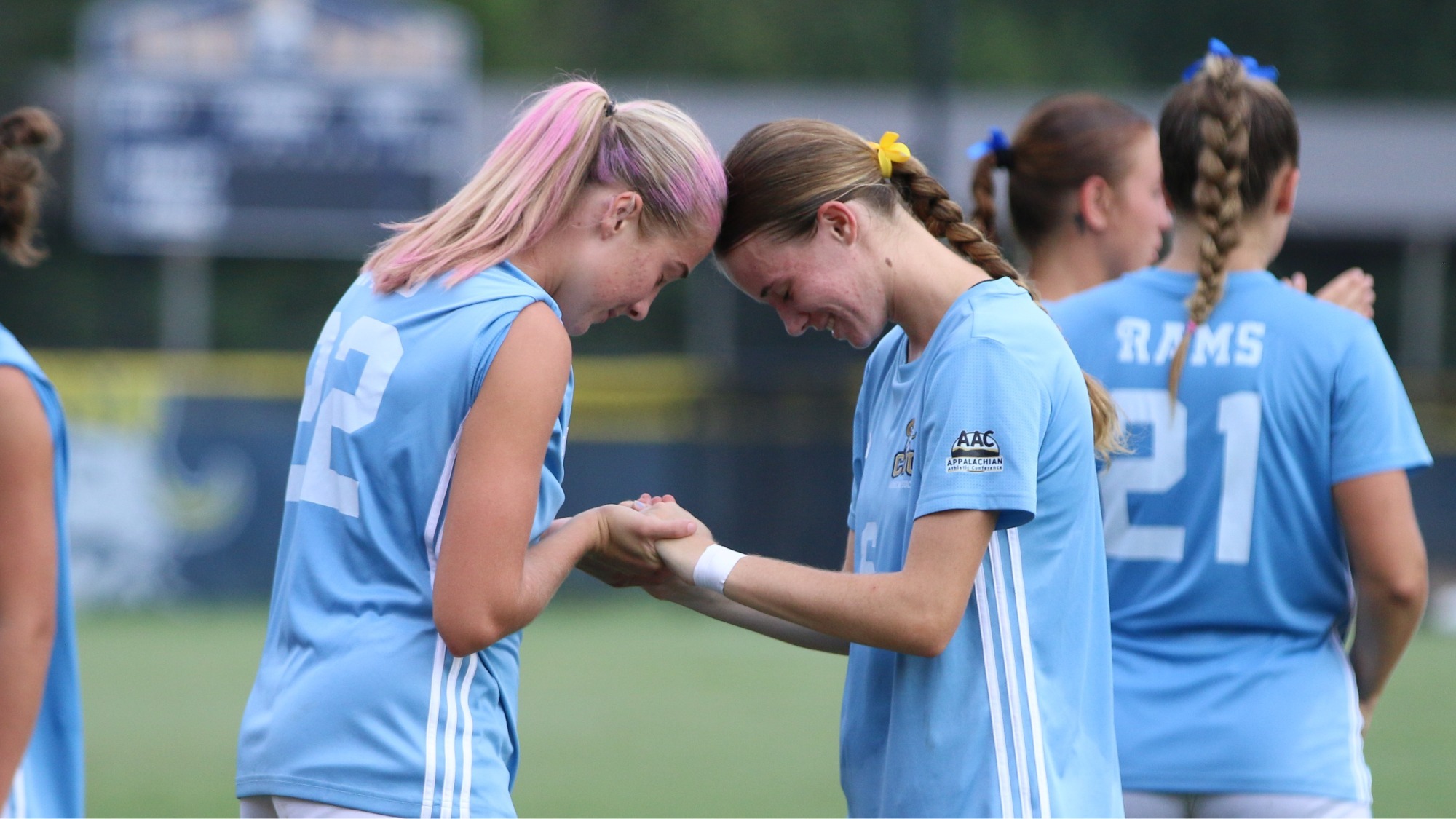 Lilly Vengelis prays with teamate Lilly Jackson