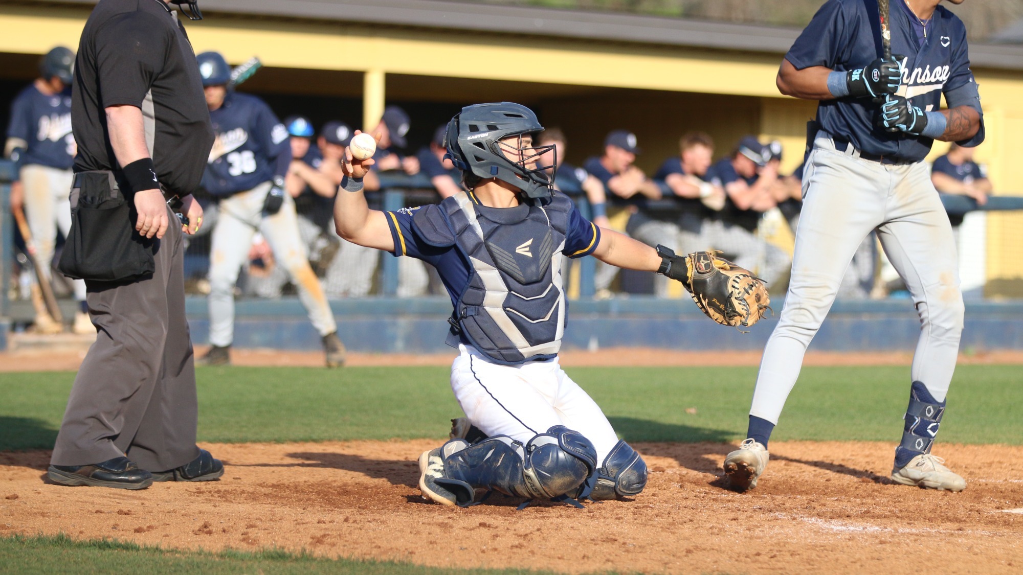 David Mora throws the ball back to the pitcher from behind home plate 
