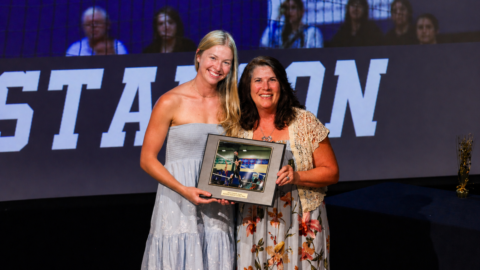 Lydia Gustafson recieves the Darren Richie Female Athlete of the Year Award from Claire Richie 
