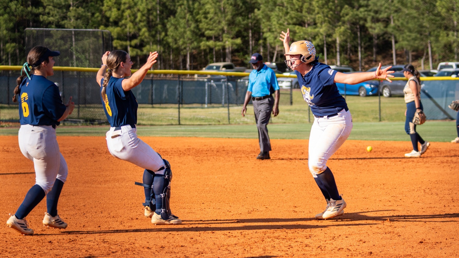 CIU softball celebrates after a hit 