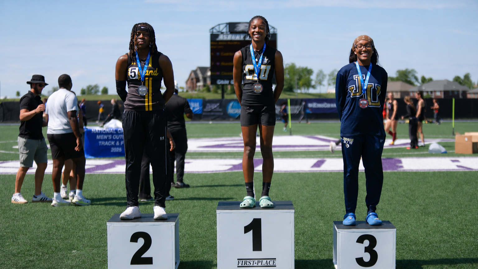 Arion Jefferson stands on the poduim after wining the 400m