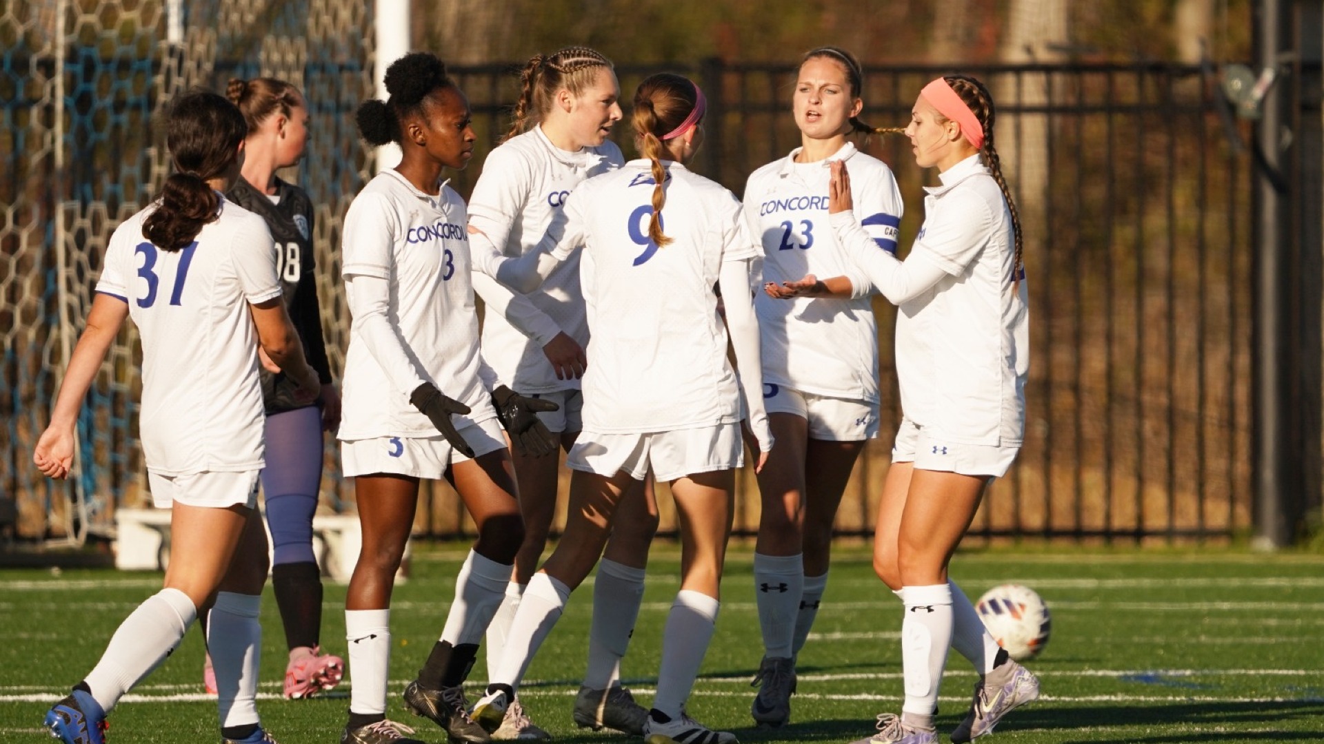 The women's soccer team celebrating together.