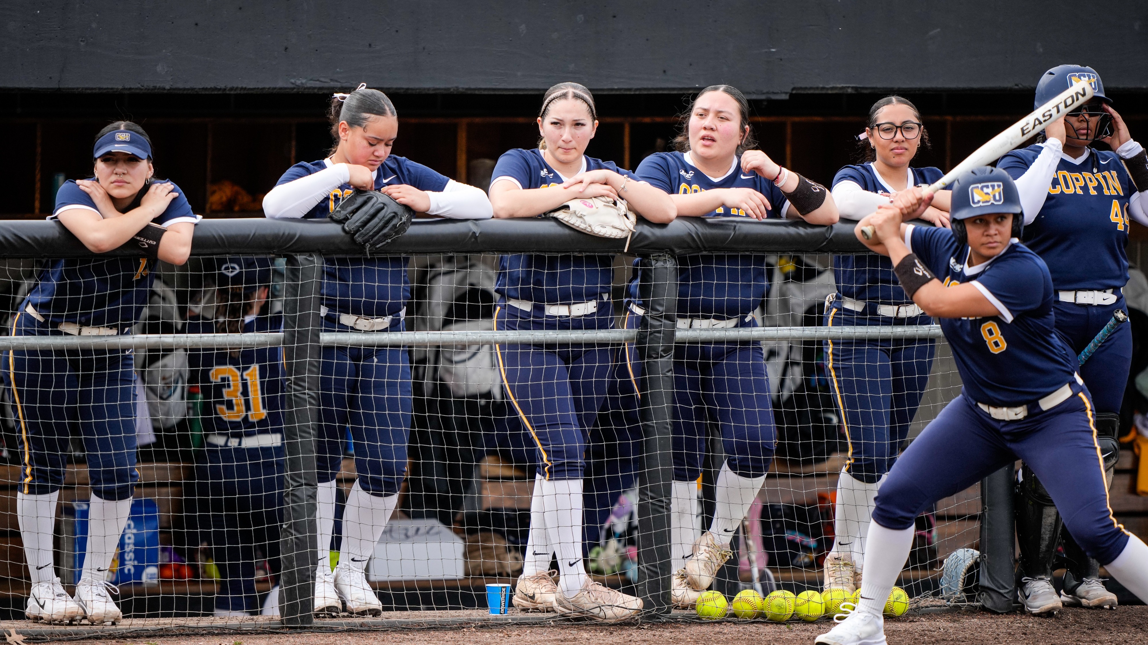 Softball Team Looks On As Teammate Hits at Towson
