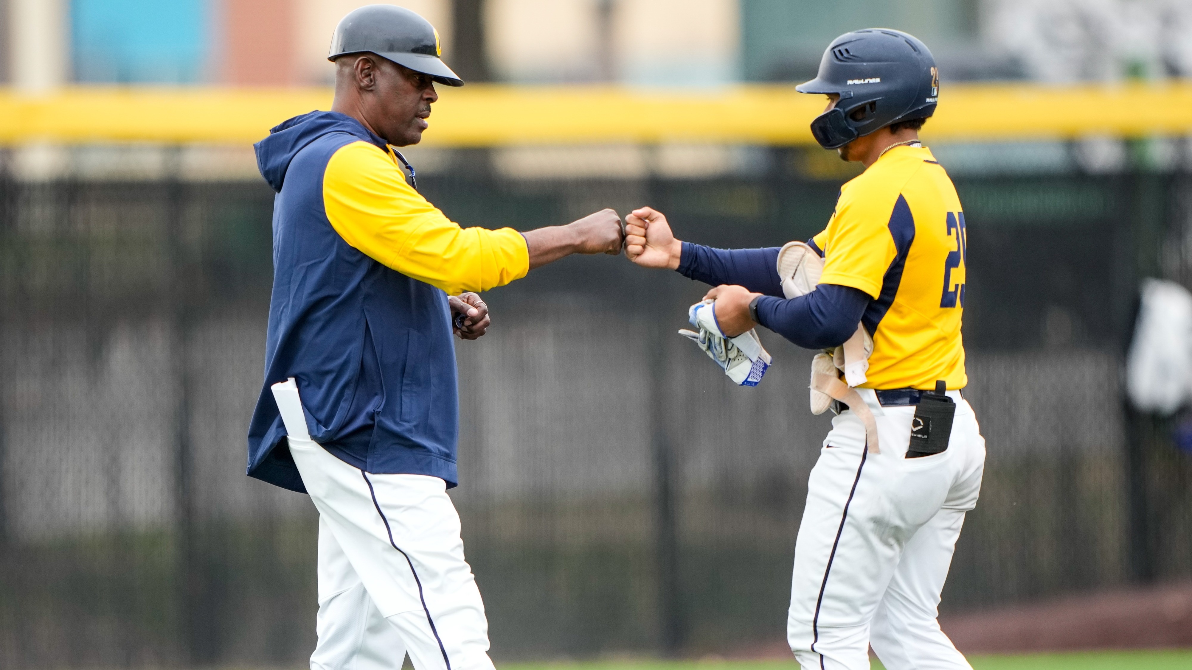 Garcia, Coach Reed fist bump after a base hit vs UMES