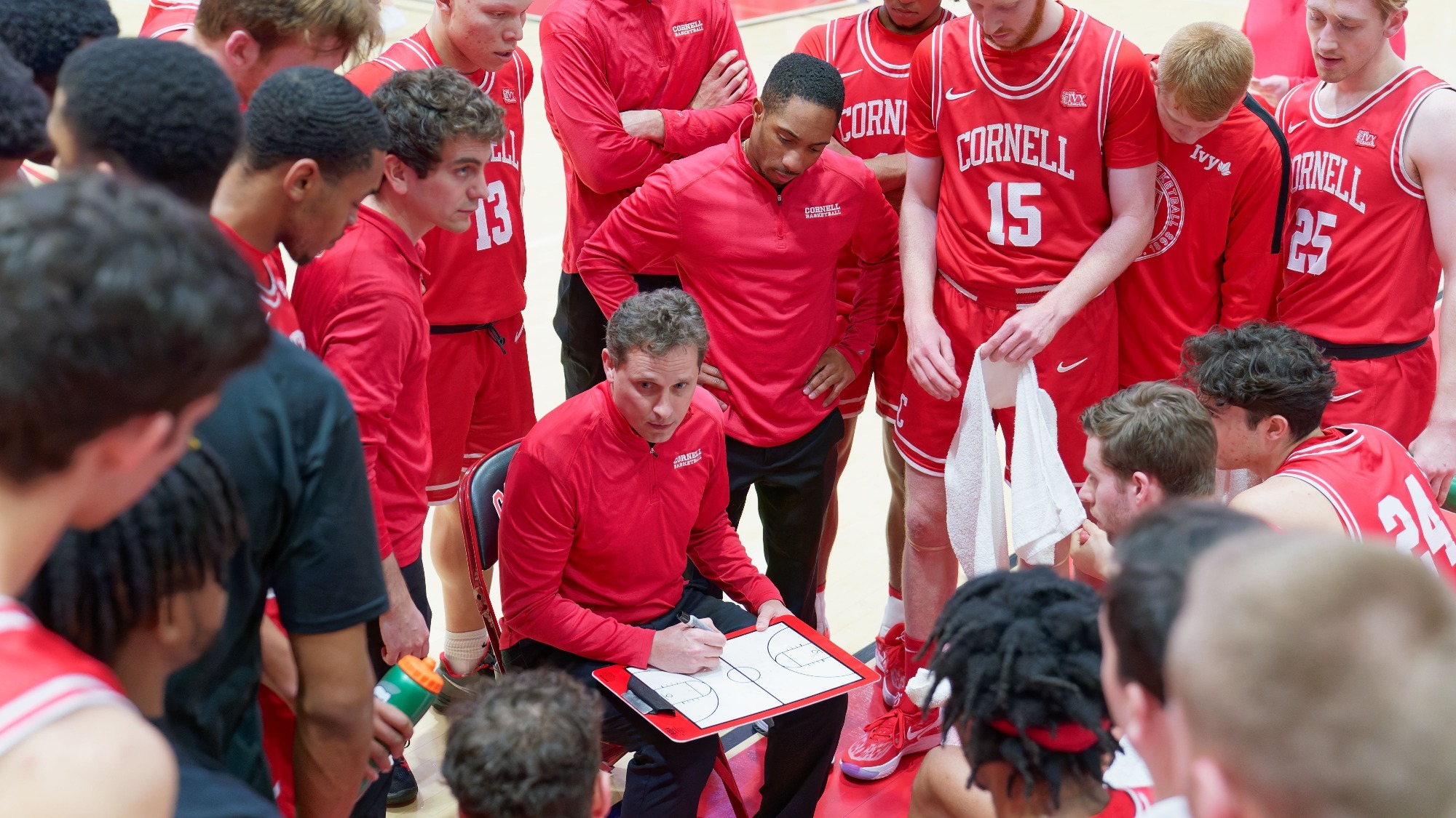 Head coach Brian Earl draws up a play during the Cornell men's basketball team's 73-56 loss to Harvard on Saturday, Feb. 18, 2023 at Newman Arena in Ithaca, N.Y.