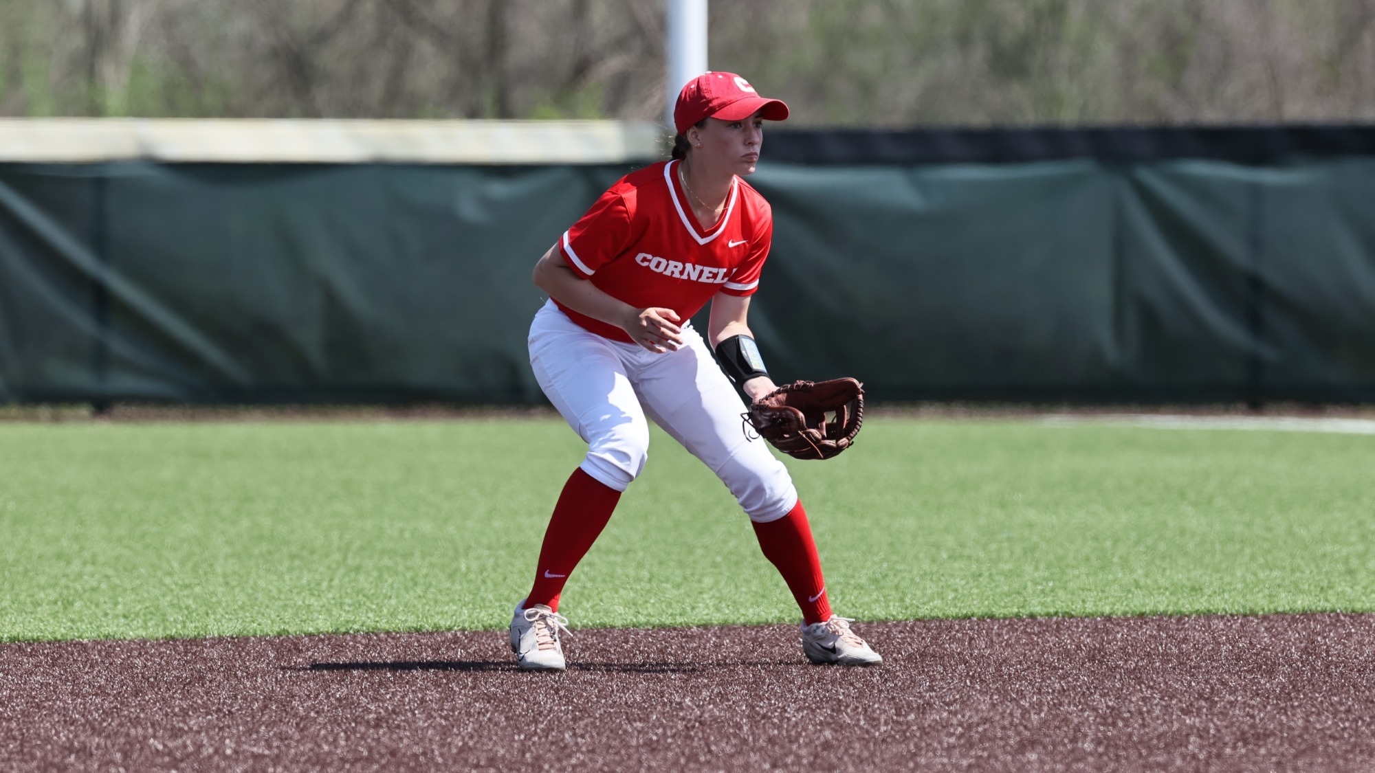 Cornell softball player prepares for action in the infield.