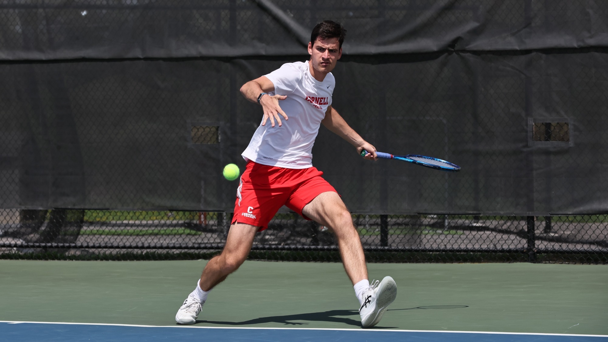 Petar Teodorovic gets ready to return a tennis ball during a match for the Cornell men's tennis team in 2023.