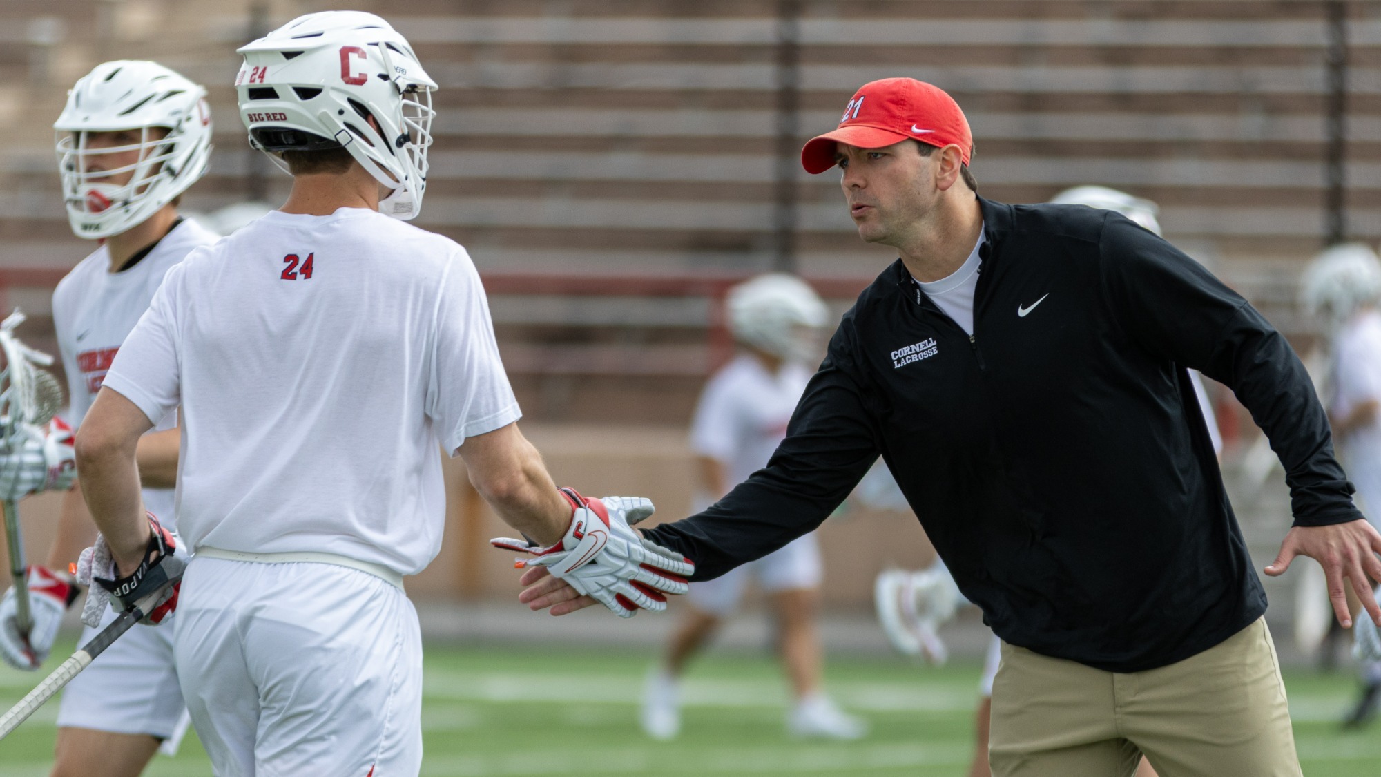 Coach Buczek and Jack Parker high five before playing Harvard.