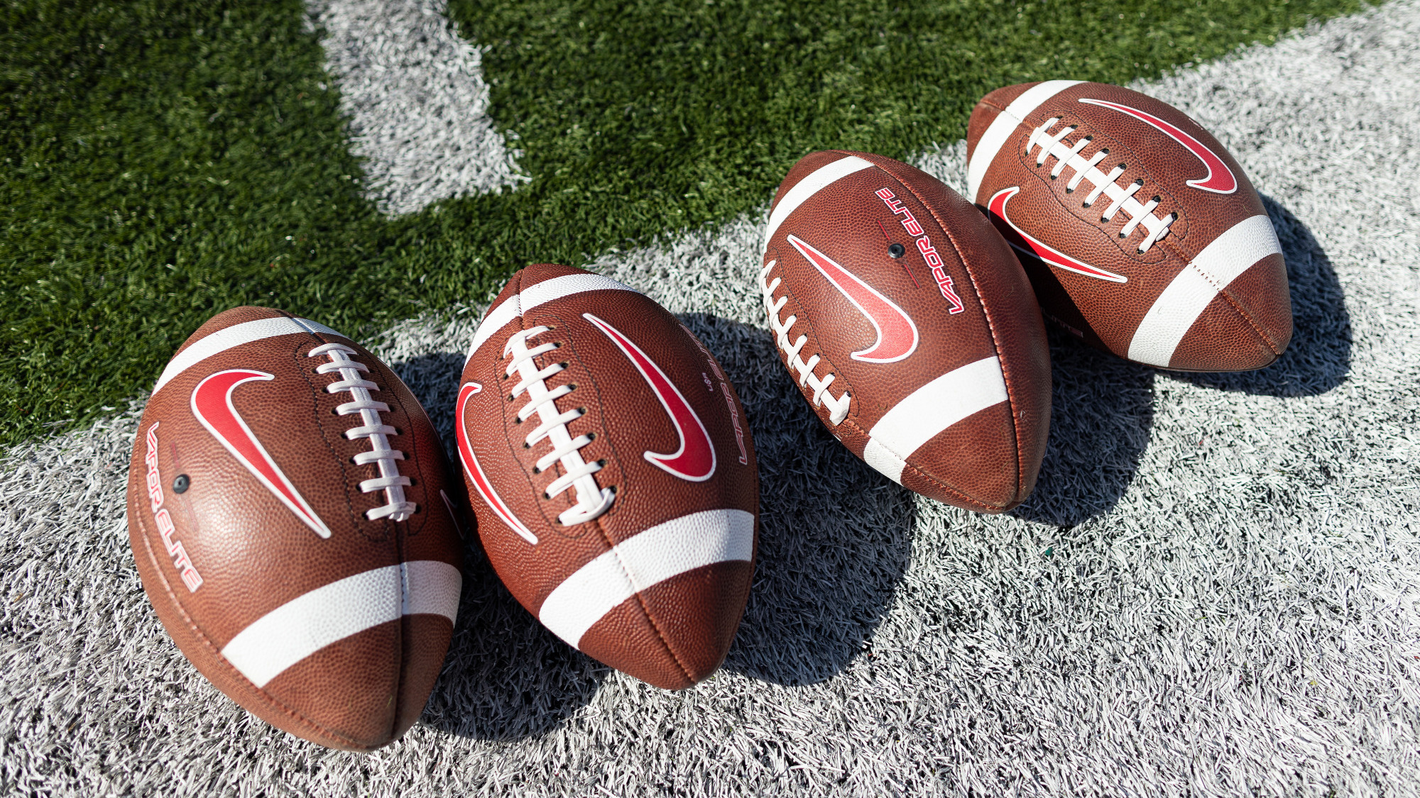Four footballs are lined up on the sideline prior to Cornell football's contest against Colgate on Sept. 30, 2023, at Schoellkopf Field in Ithaca, N.Y.