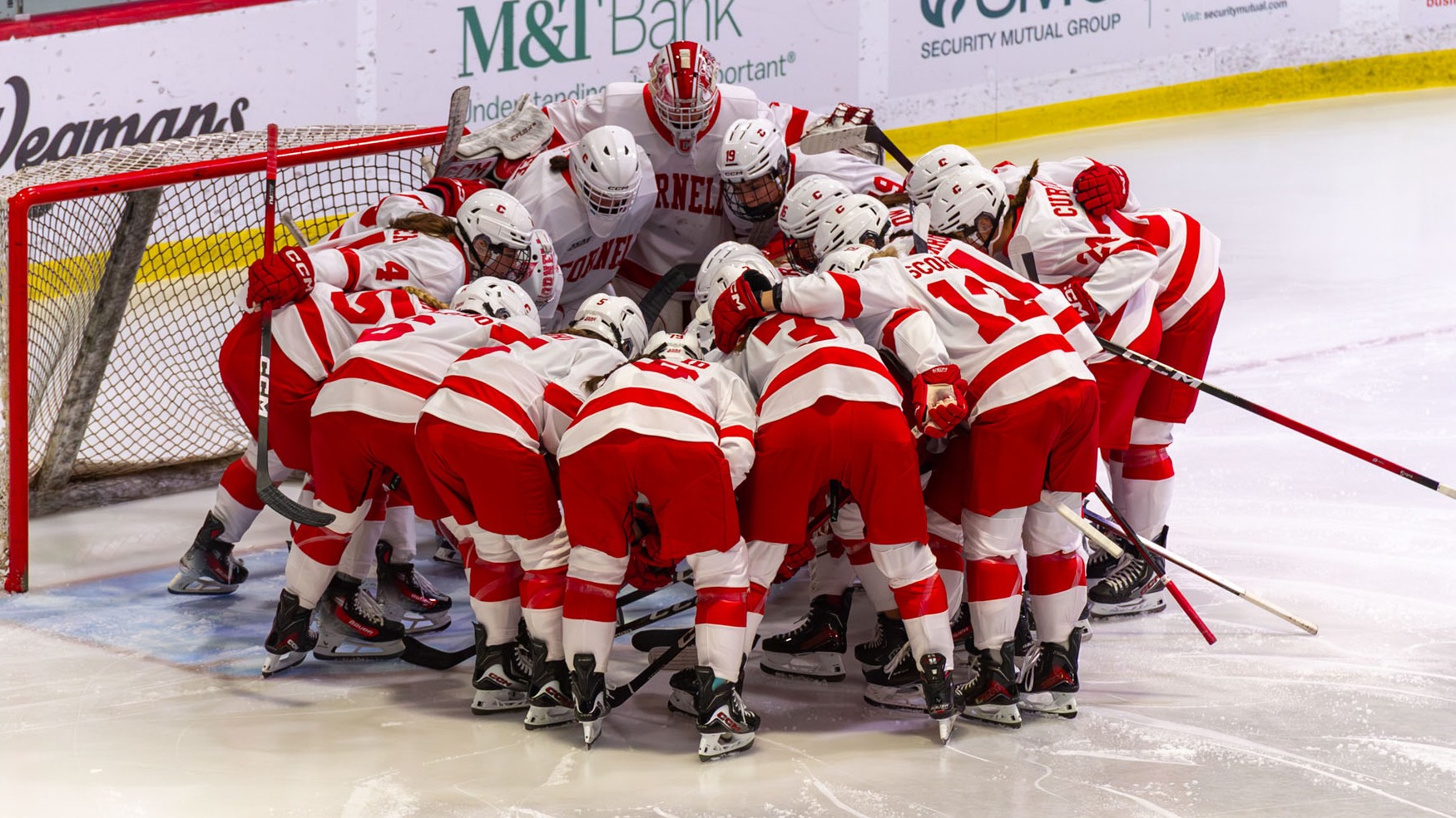 Cornell women's ice hockey huddles at the net before action at Lynah Rink.