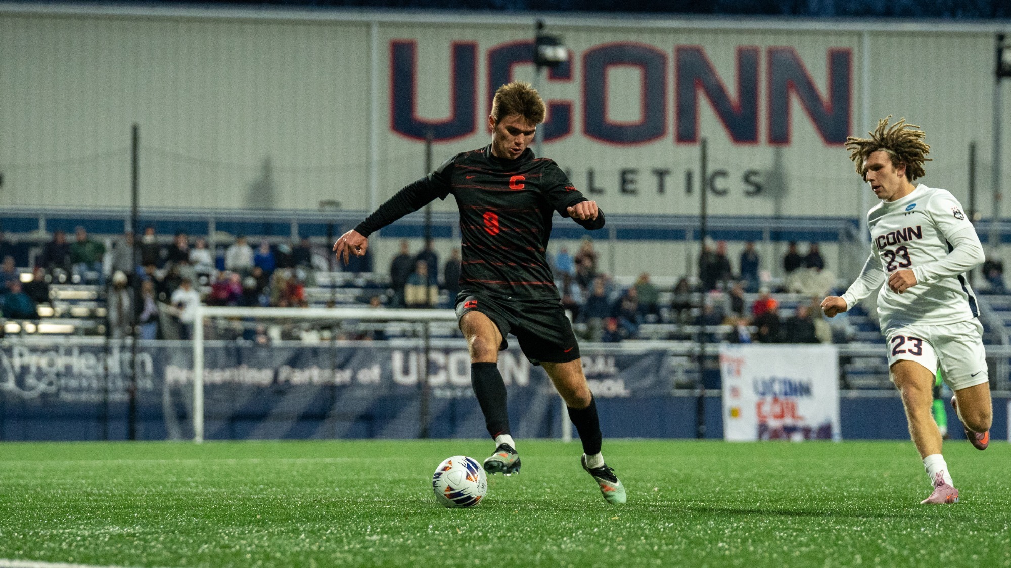 Nate Hovan dribbles the ball against the UConn Huskies in the NCAA College Cup.