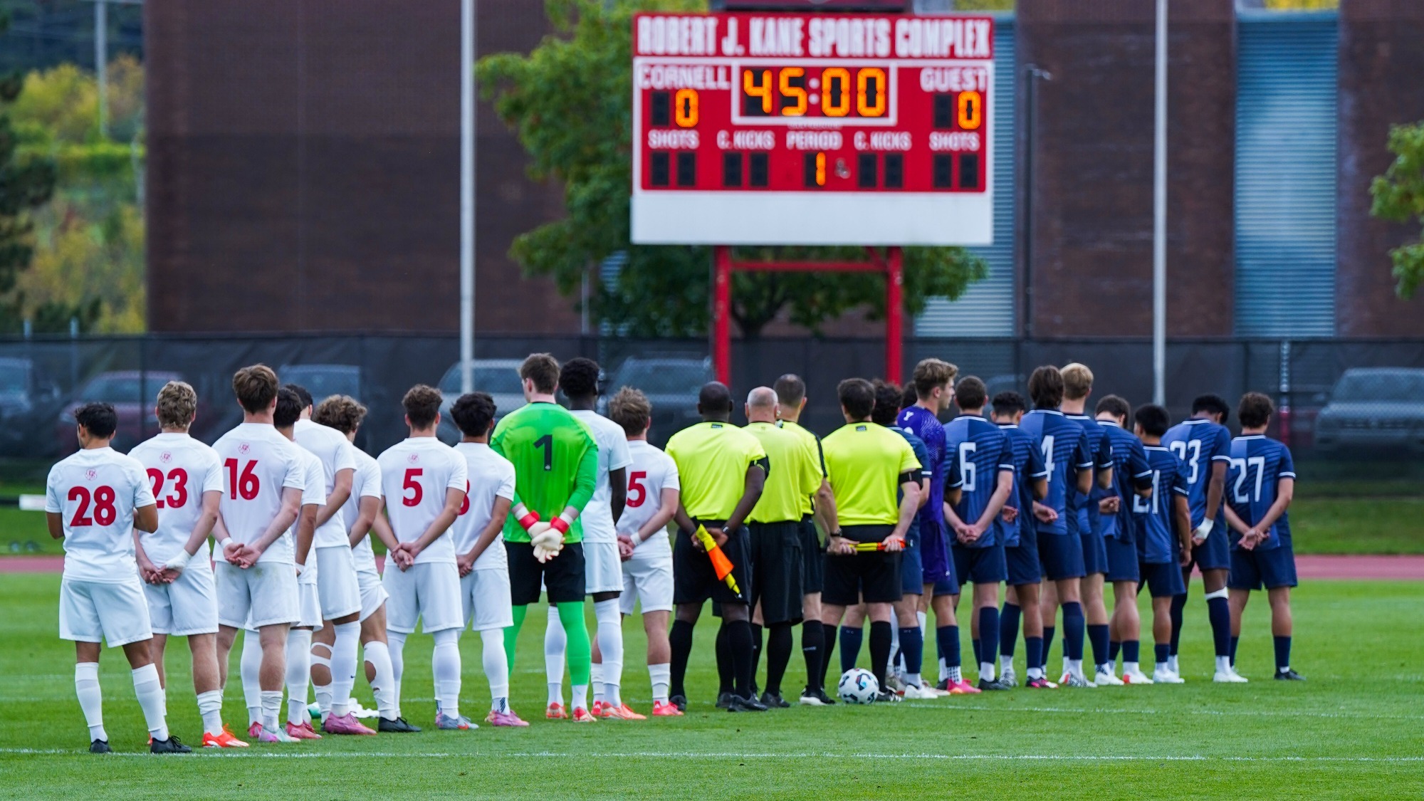 Cornell men's soccer and Yale lines up for the national anthem at Berman Field.